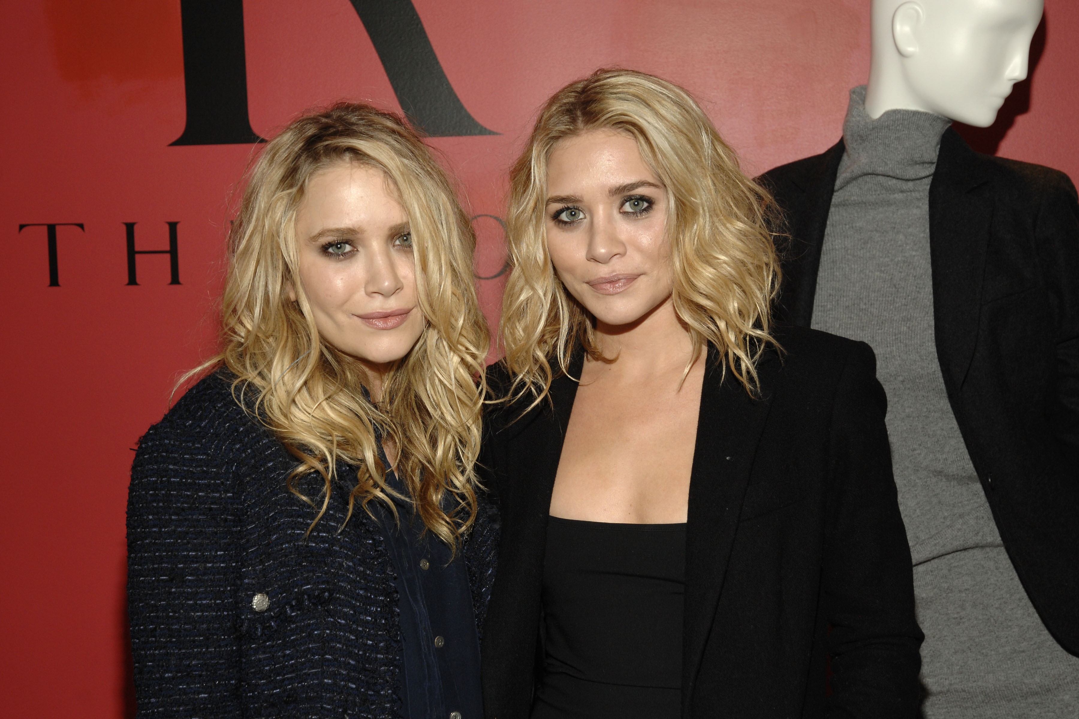 Defined jawlines, sculpted cheekbones, and signature hazy smoky eyes cemented a high-fashion, editorial identity for the 23-year-old designers on September 16, 2009, with tousled blonde waves falling effortlessly over tailored dark blazers at a Bergdorf Goodman collection preview.