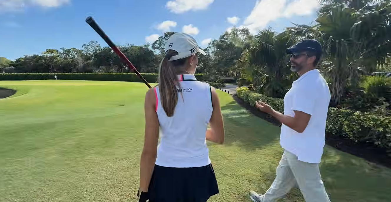 Kai Trump and Donald Trump Jr. talk beside a golf green during her recovery from wrist surgery. Although she could practice putting, she said she was not yet able to hit a regular golf shot. | Source: Youtube/kaitrump