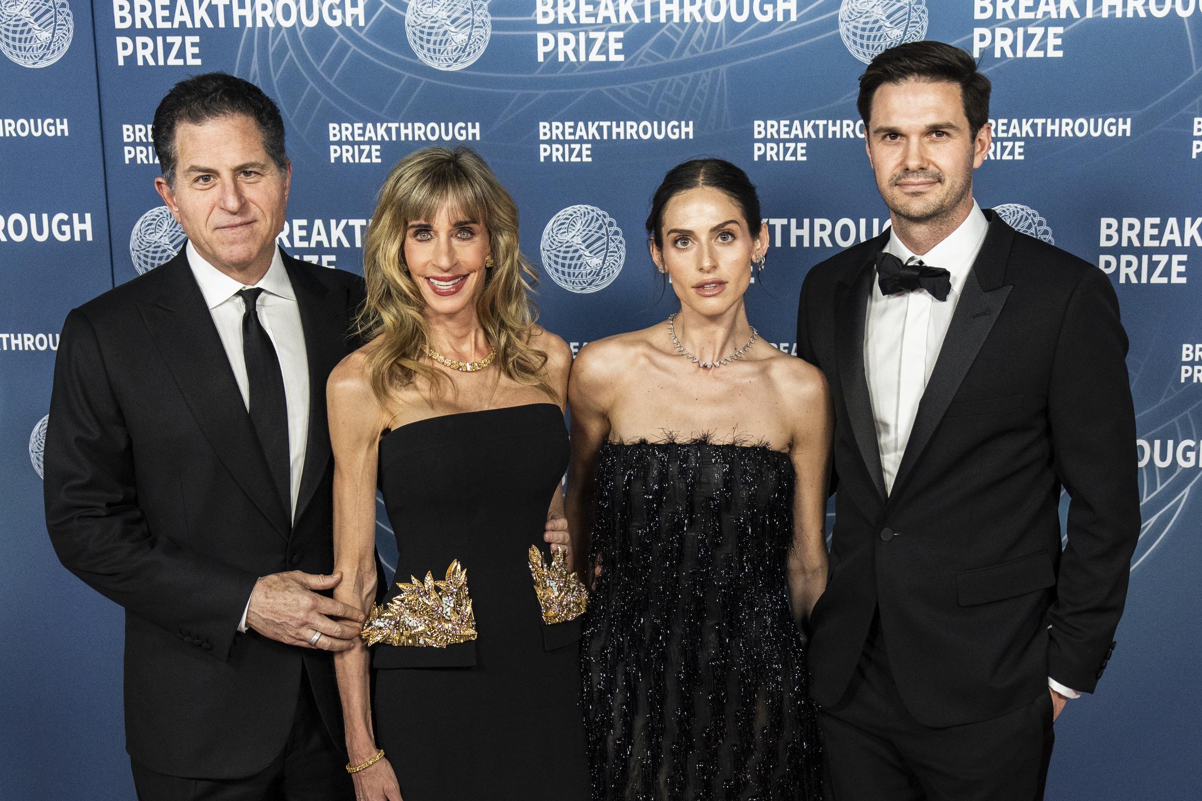 Susan Dell attends the Breakthrough Prize Ceremony at Barker Hangar in Santa Monica, California, with her husband Michael Dell, daughter Alexa Dell and Fred Choquette. She posed in a sleek strapless black gown with statement gold detailing at the waist.