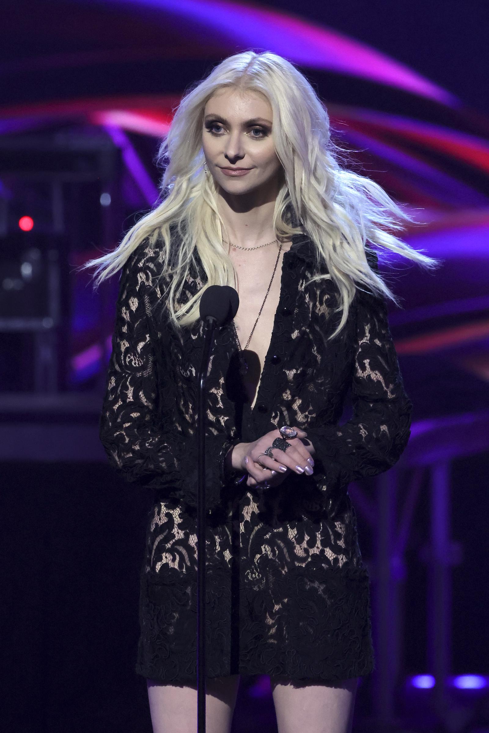 Taylor Momsen, who has fully embraced an all-black dress code, speaks onstage at the iHeartRadio Music Awards in Los Angeles. She’s come a long way, yet still carries the same fearless confidence she showed in her early interviews.