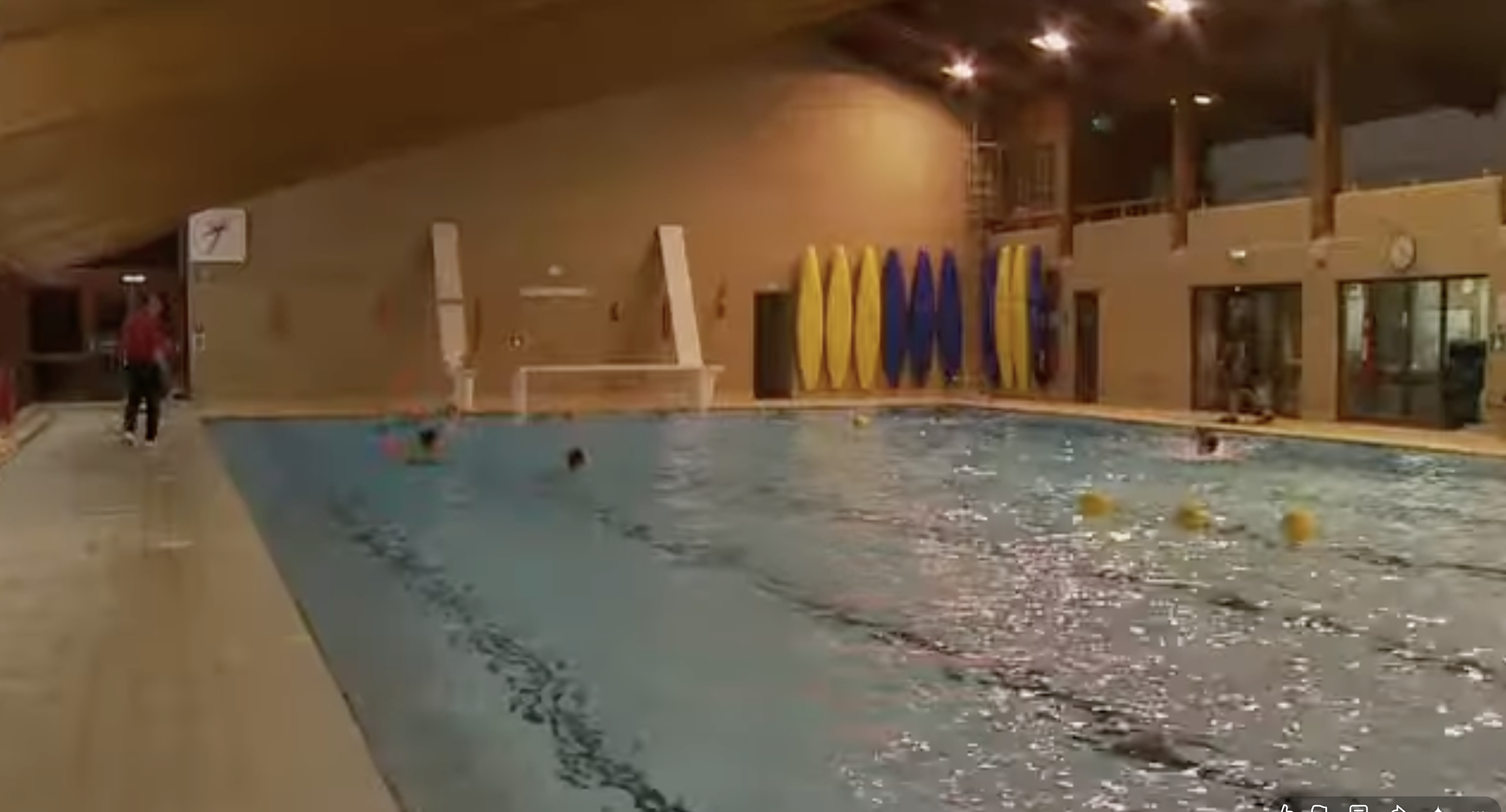Swimmers use an indoor pool equipped with marked lanes and swimming equipment. The facility offers a look at the sports and recreational spaces featured in footage of Eton College. | Source: Youtube/Paradoxyy