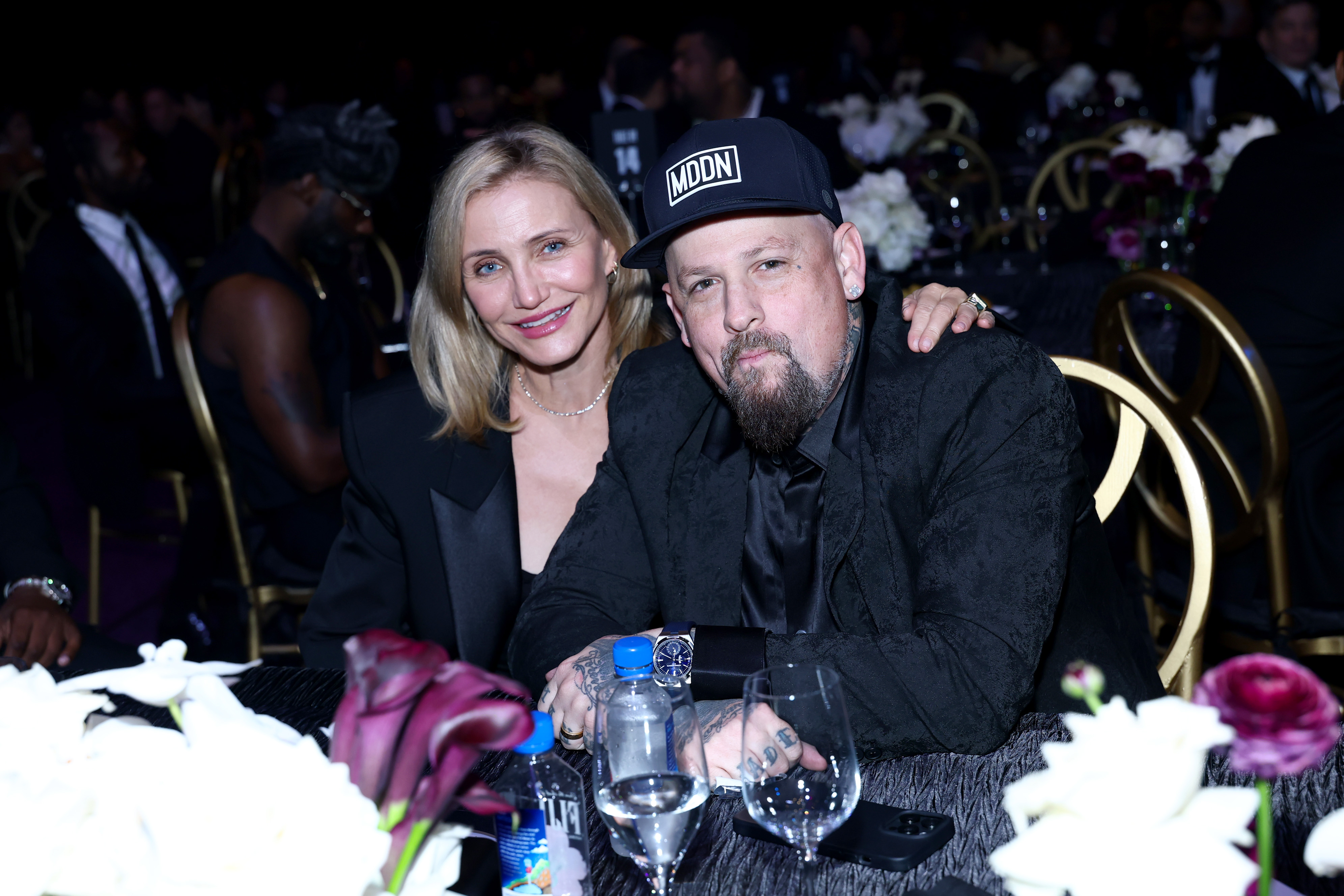 At the casino night event, Diaz and Madden were photographed seated together at a candlelit table, surrounded by roses and glasses of wine. Cameron leaned in close with a smile, her hand resting on her husband's shoulder.