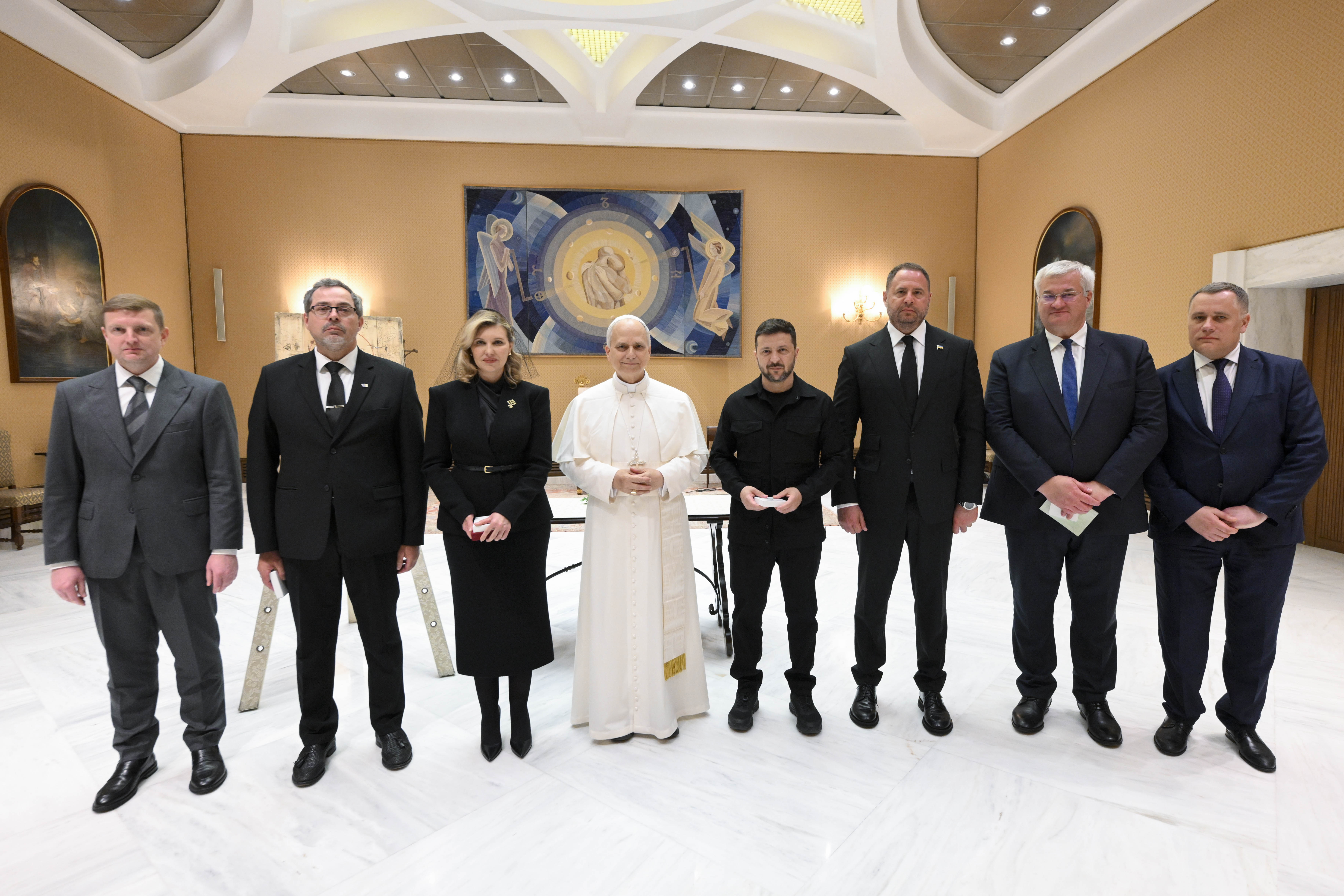 Ukrainian President Volodymyr Zelenskyy, First Lady Olena Zelenska, and members of their delegation pose with Pope Leo XIV at the Vatican on May 18, 2025, after a private audience held following the papal inauguration Mass.