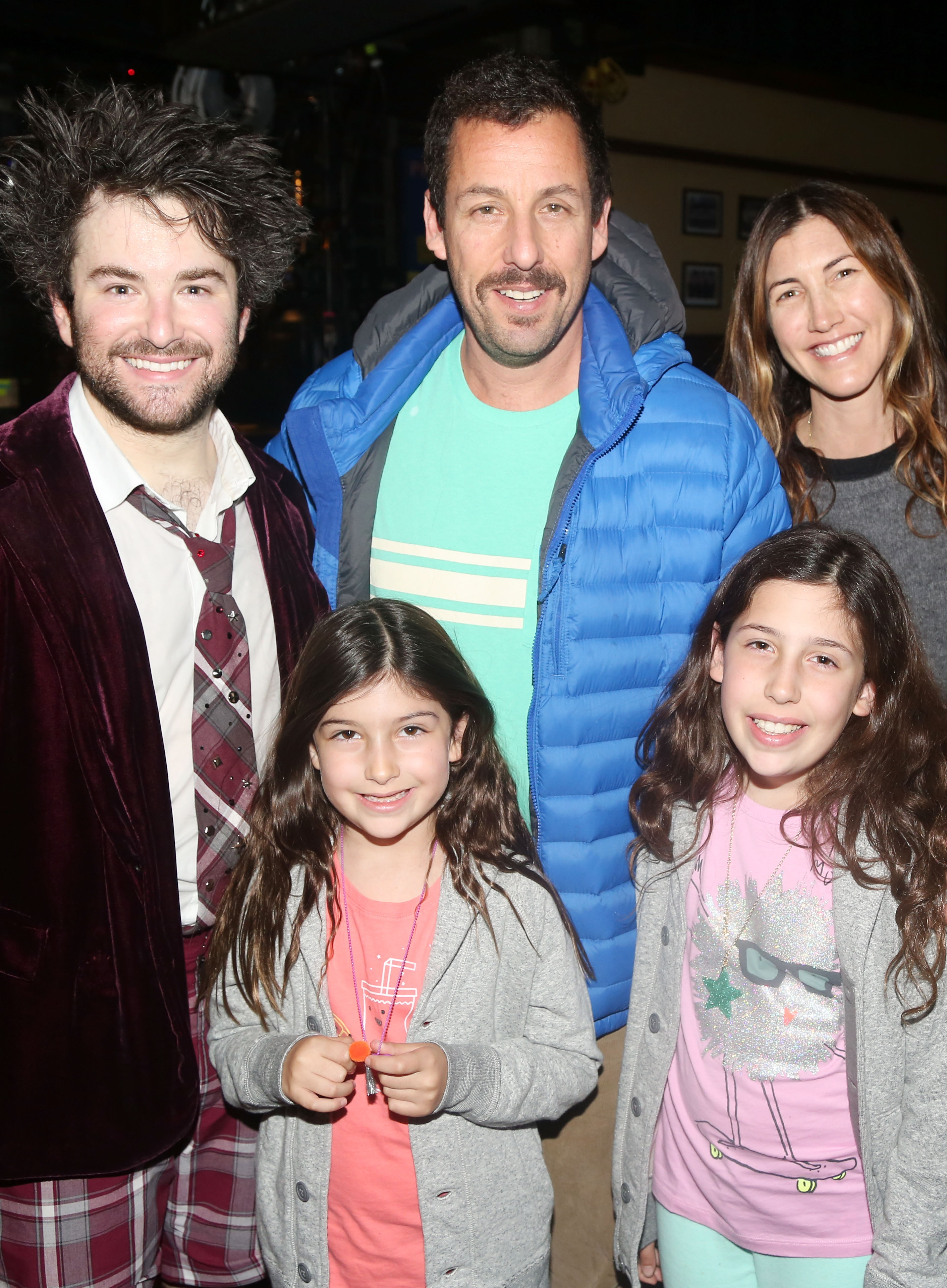 Alex Brightman joins Adam Sandler and Jackie Sandler as Sunny and Sadie Sandler stand front and center backstage at School of Rock on Broadway. With Brightman in character-inspired flair and the Sandlers in casual layers, the group gathers for a cheerful post-show moment inside the Winter Garden Theater.