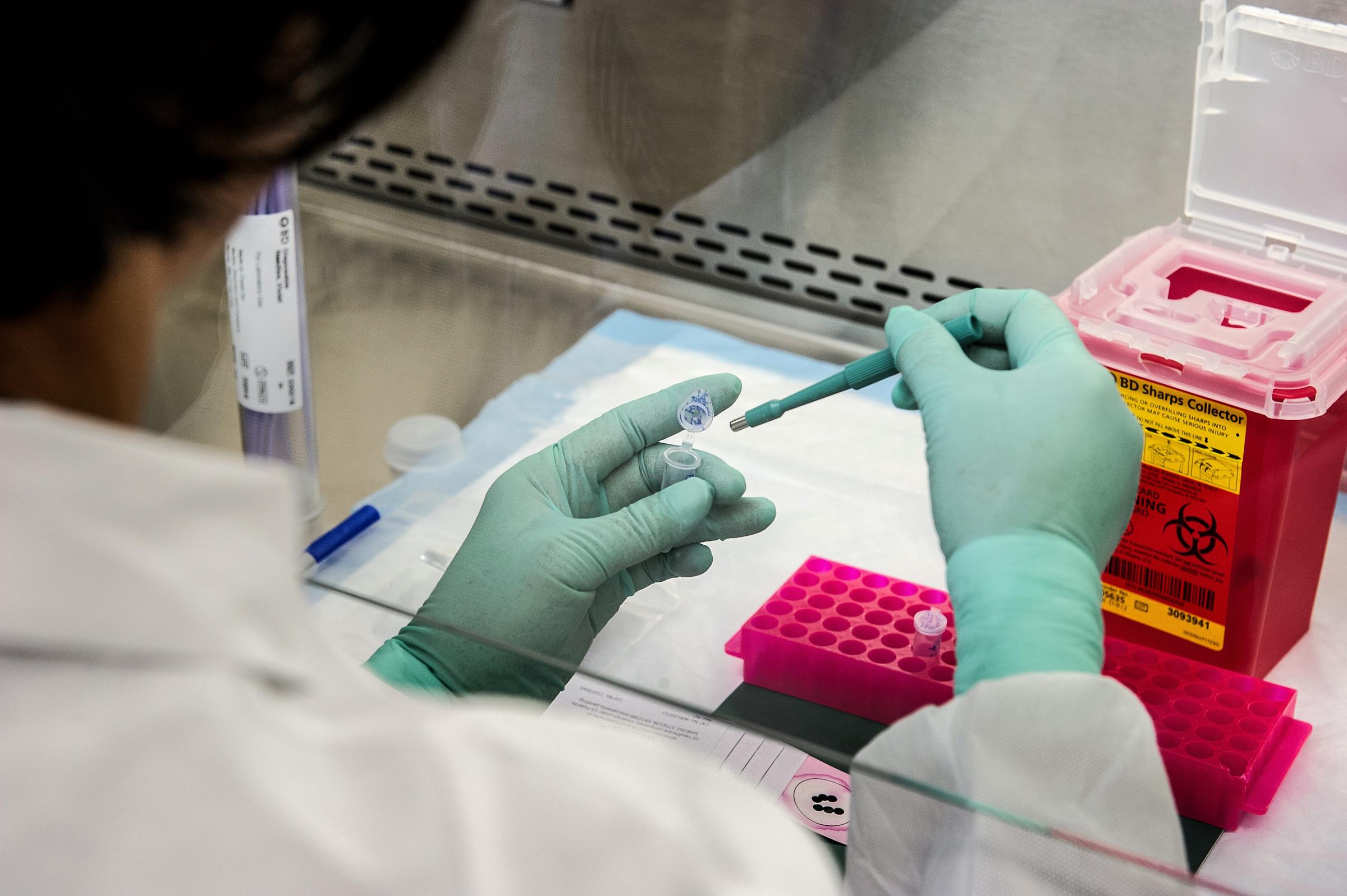 A laboratory technician examines a sample as part of cancer research, which helps scientists develop more effective methods of diagnosis and treatment. | Source: Getty Images.