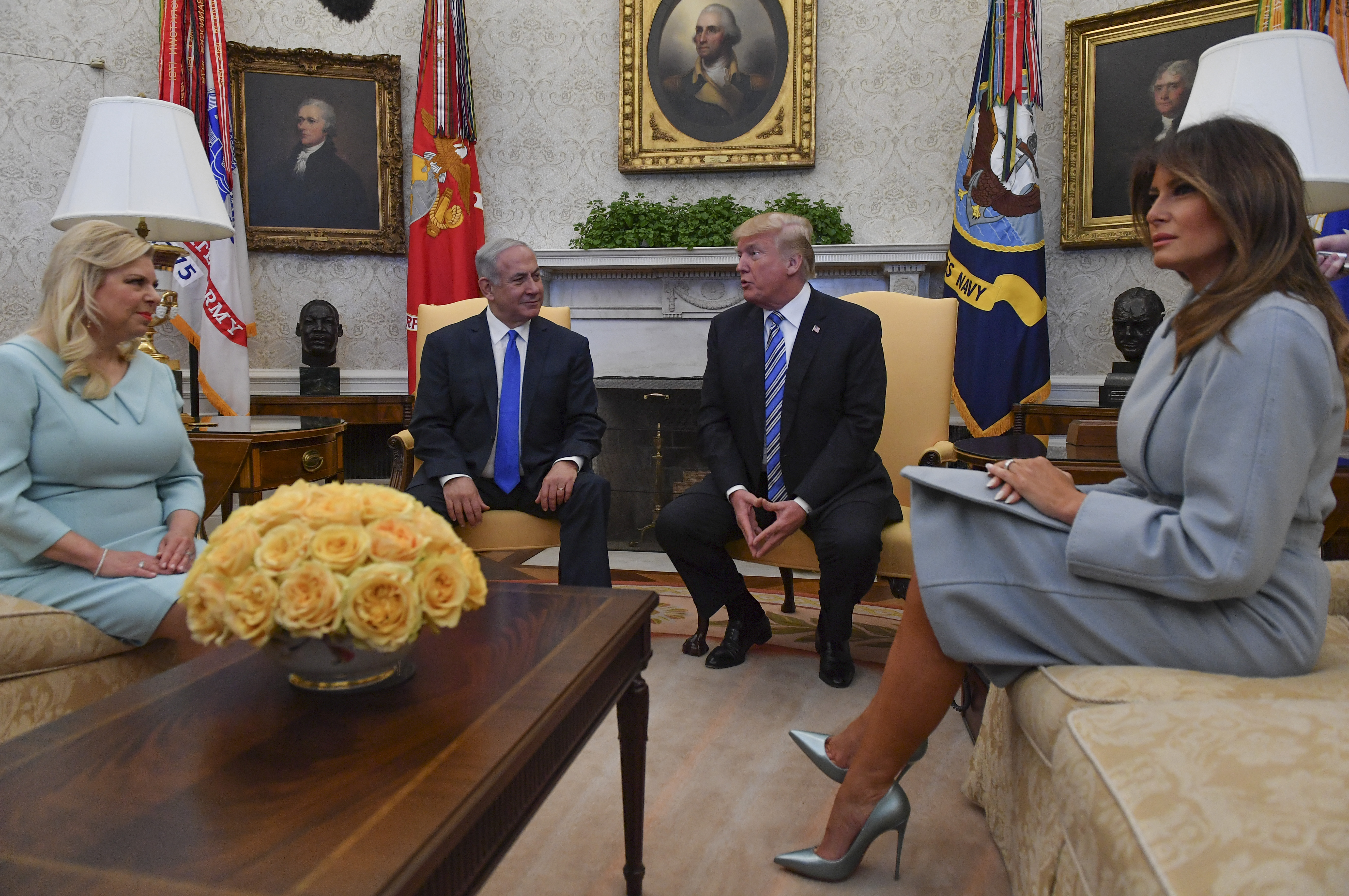 First Lady Melania Trump sits in the Oval Office at the White House on March 5, 2018, during a meeting with Israeli Prime Minister Benjamin Netanyahu and Sara Netanyahu, wearing a structured powder-blue skirt suit paired with metallic icy-blue pointed-toe pumps that elevate the formal tailoring with needle-thin stiletto heels.