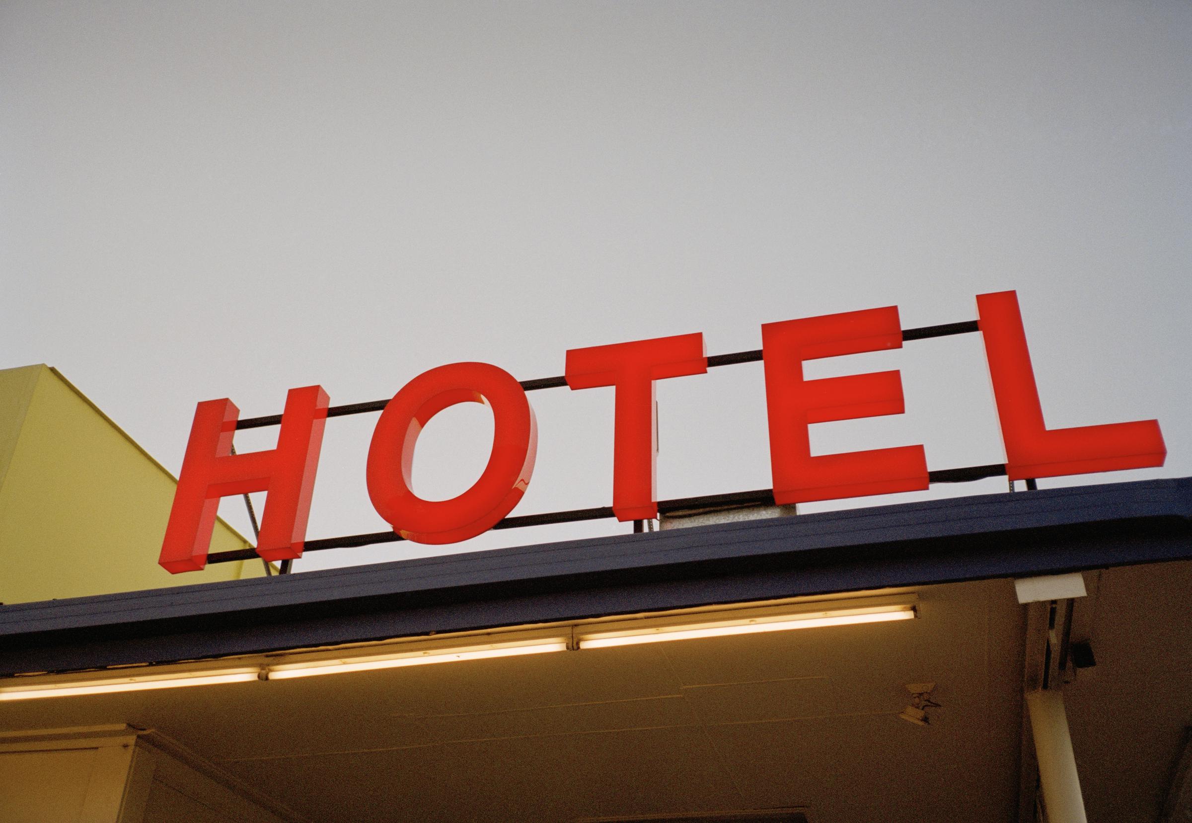 Illuminated hotel sign. | Source: Getty Images