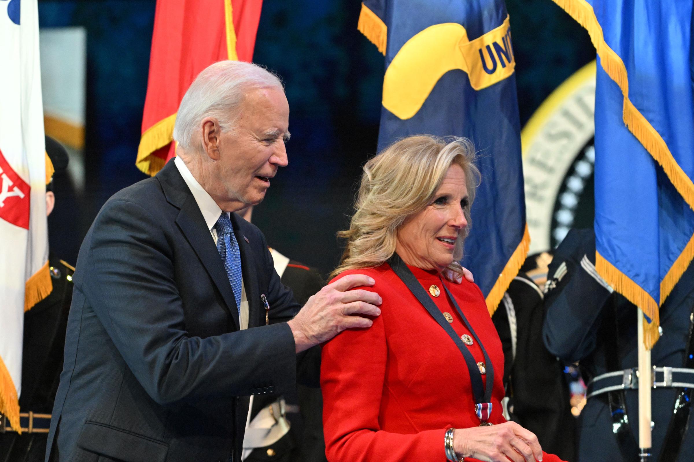 Joe Biden embraces Jill Biden after she received a medal for distinguished public service at a Department of Defense Commander in Chief Farewell Ceremony on January 16, 2025 | Source: Getty Images