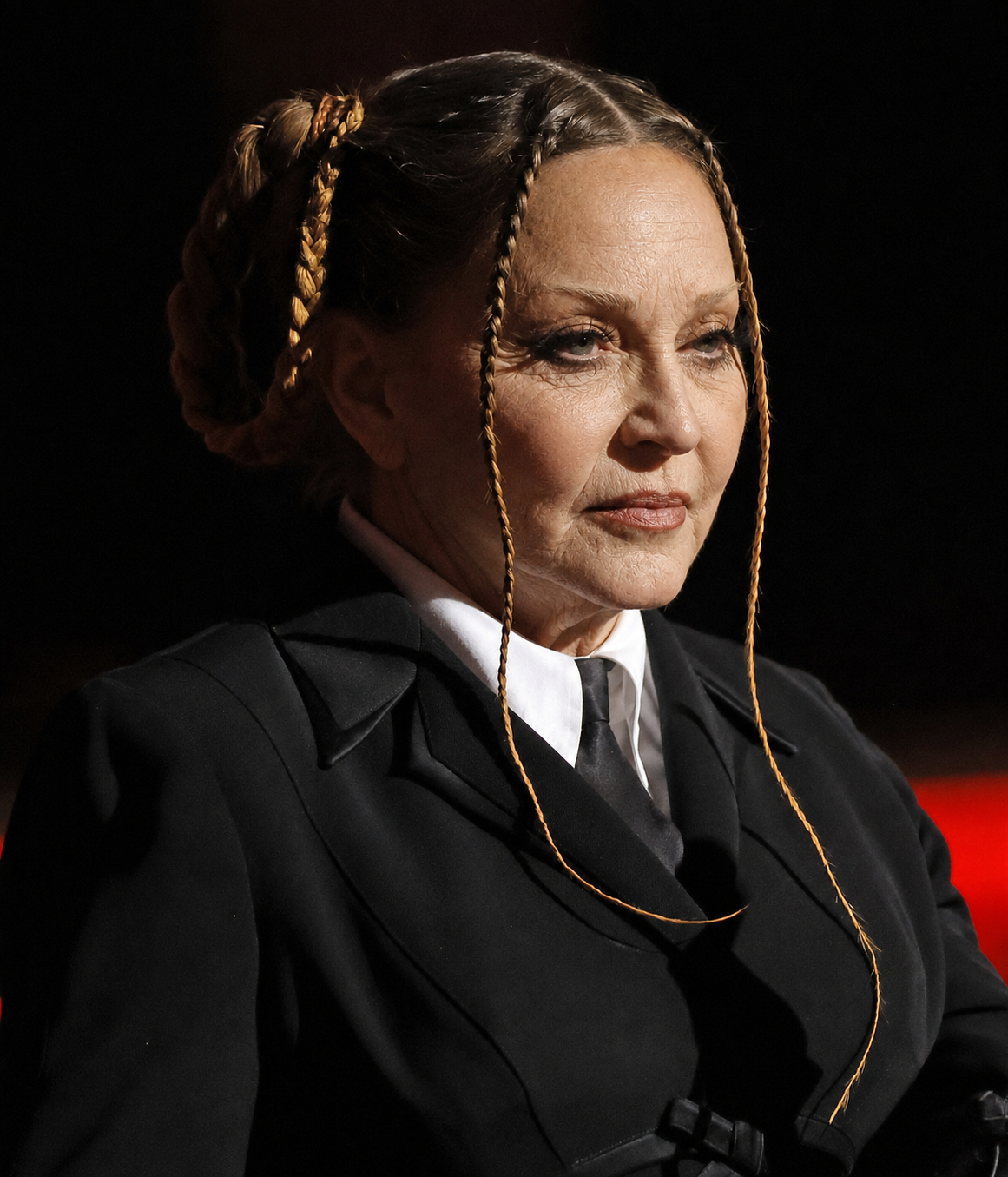 The AI interpretation keeps Madonna's structured black ensemble and braided hairstyle while giving her face more pronounced signs of aging. | Source: Chat GPT