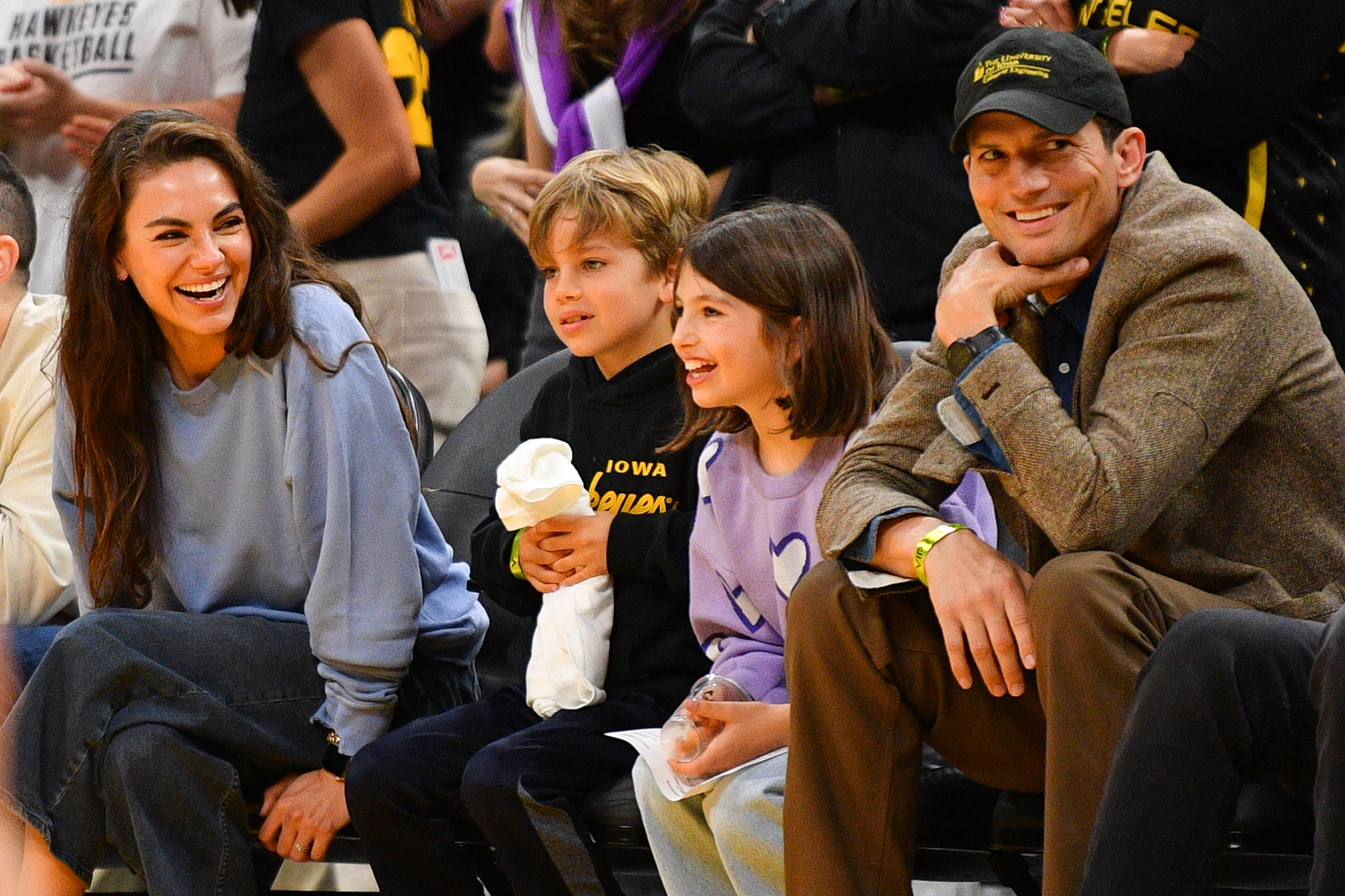 Mila Kunis and Ashton Kutcher with their children during the WNBA basketball game between the Indiana Fever and the Los Angeles Sparks on May 24, 2024, at Crypto.com Arena in Los Angeles, California. | Source: Getty Images