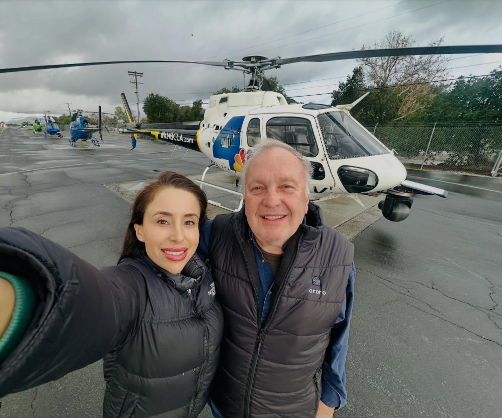 Eliana "Eli" Moreno and pilot George Marciniw pose together in a photo shared on Marciniw’s Facebook page, standing in front of a news helicopter during their years working together in aerial news coverage. | Source: Facebook/George Marciniw