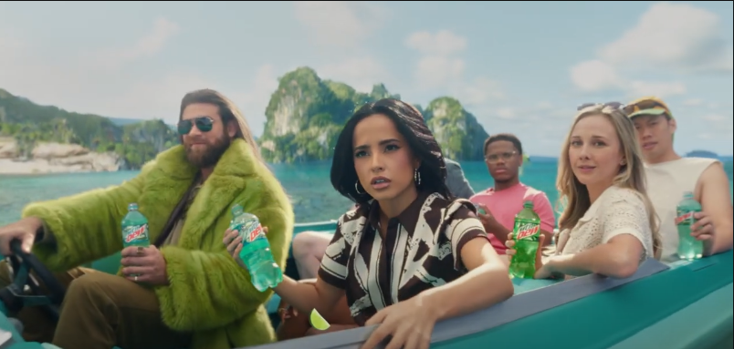 A screenshot of Becky G and Mountain Dude on a boat for Mountain Dew Baja Blast's commercial | Source: Youtube/Mountain Dew