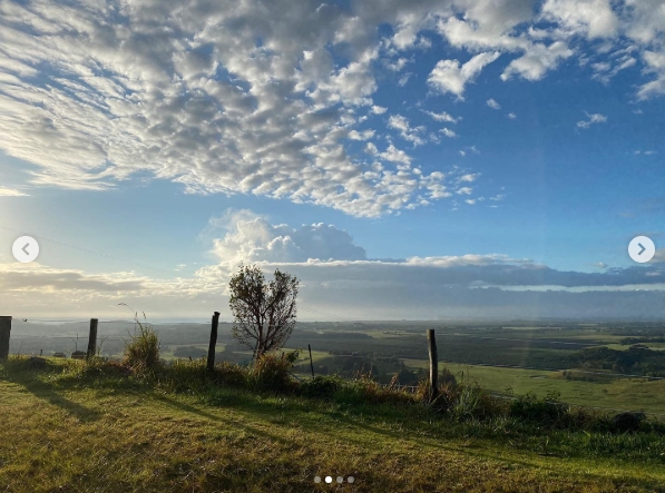 A panoramic view of the countryside stretches beyond a simple fence line, where golden light and dramatic cloud cover paint a cinematic scene across the sprawling farmland. From a post dated April 22, 2021. | Source: Instagram/nicolekidman