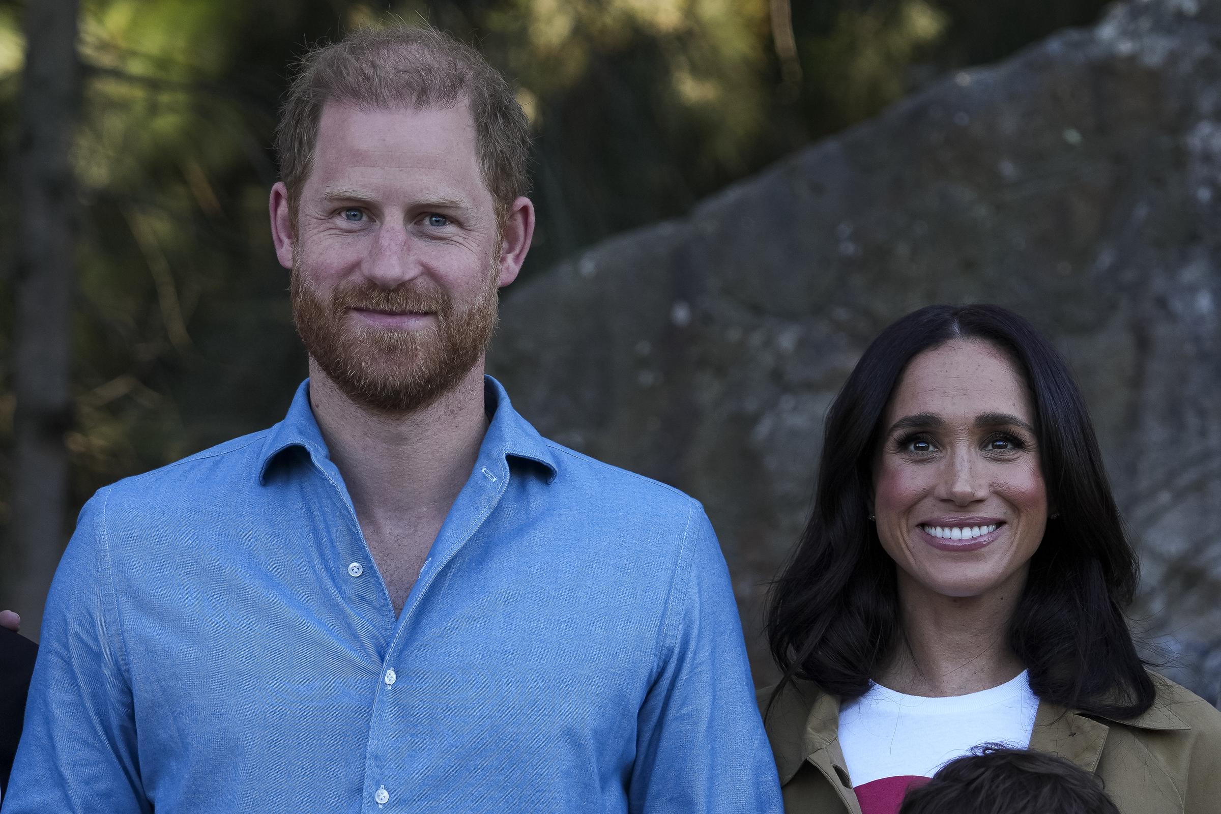 Prince Harry, Duke of Sussex, and Meghan, Duchess of Sussex, pose for a photo during a Scar Tree Walk in Melbourne, Australia, on April 16, 2026, during their four-day visit to the country. | Source: Getty Images.