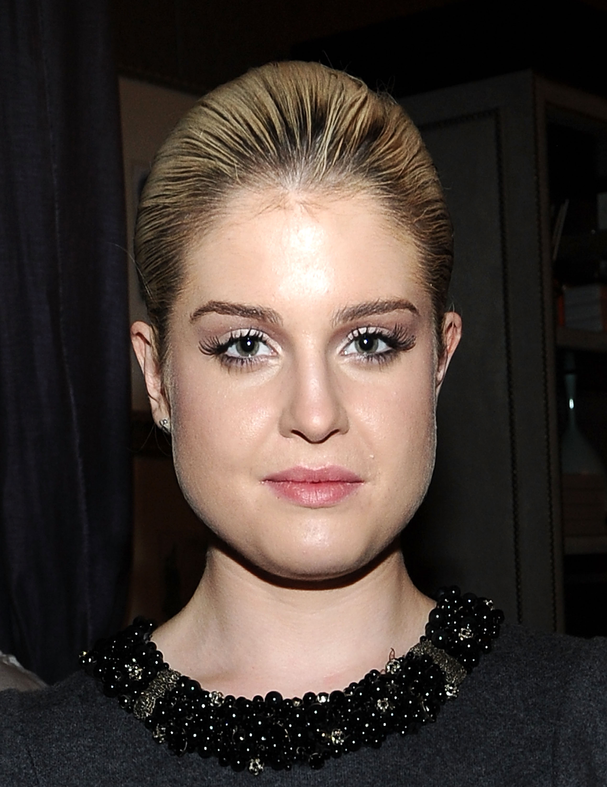 Kelly Osbourne attends Mercedes-Benz Fashion Week in New York City in September 2011, showcasing a sleek, swept-back hairstyle and understated makeup as she embraced a more sophisticated, high-fashion image. | Source: Getty Images