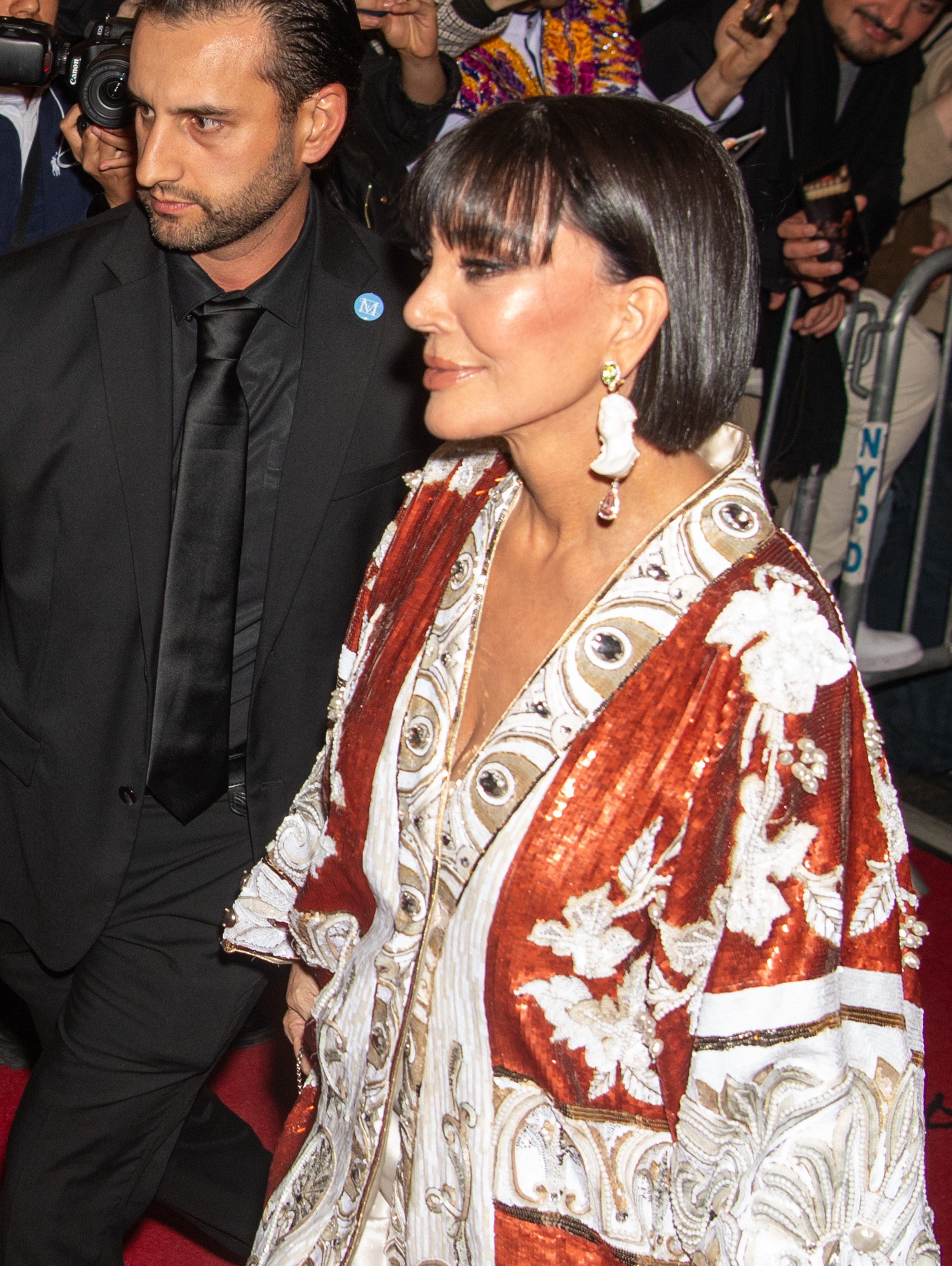 Kris Jenner is captured in profile as she makes her way through the Met Gala, showcasing her statement earrings and sleek bob. | Source: Getty Images