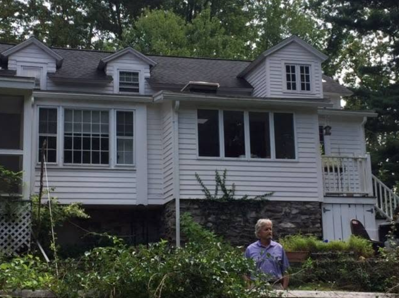 Another view reveals the back of Michael's former home, with dormer windows, a stone foundation, and a garden surrounding the house. Douglas lived here with his mother, Diana, his brother, Joel, and his stepfather, William Darrid. | Source: Facebook/MichaelDouglasOfficial