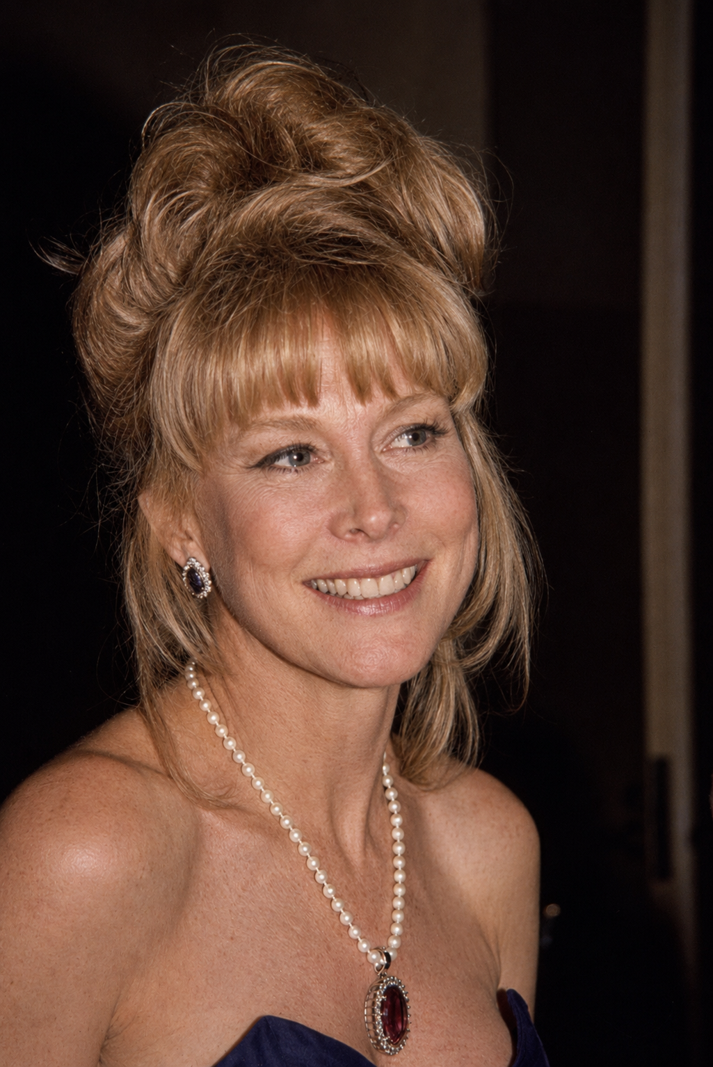 A digitally reimagined portrait shows Barbara Eden with softer facial contours and more visible natural signs of aging while preserving her signature smile and voluminous blonde hairstyle. | Source: ChatGPT