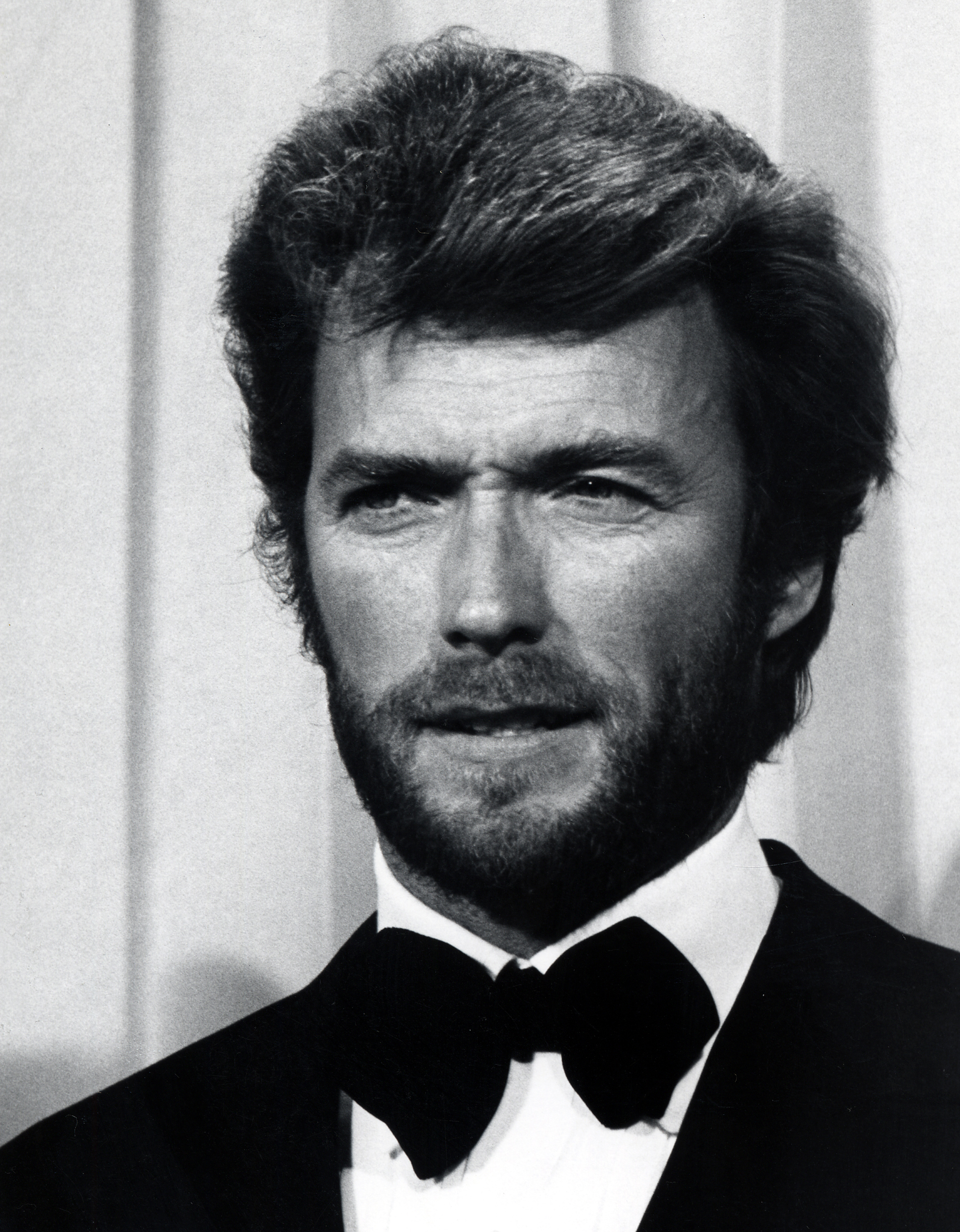 Clint Eastwood brought a more formal look to the 42nd Annual Academy Awards at the Dorothy Chandler Pavilion in Los Angeles, California, on April 7, 1970. Dressed in a classic tuxedo and bow tie, the 39-year-old actor also sported a full beard beneath his thick, neatly styled hair. The close-up captured Clint's unmistakable gaze and facial structure — another snapshot of the younger star whose likeness to Scott would become a talking point generations later.