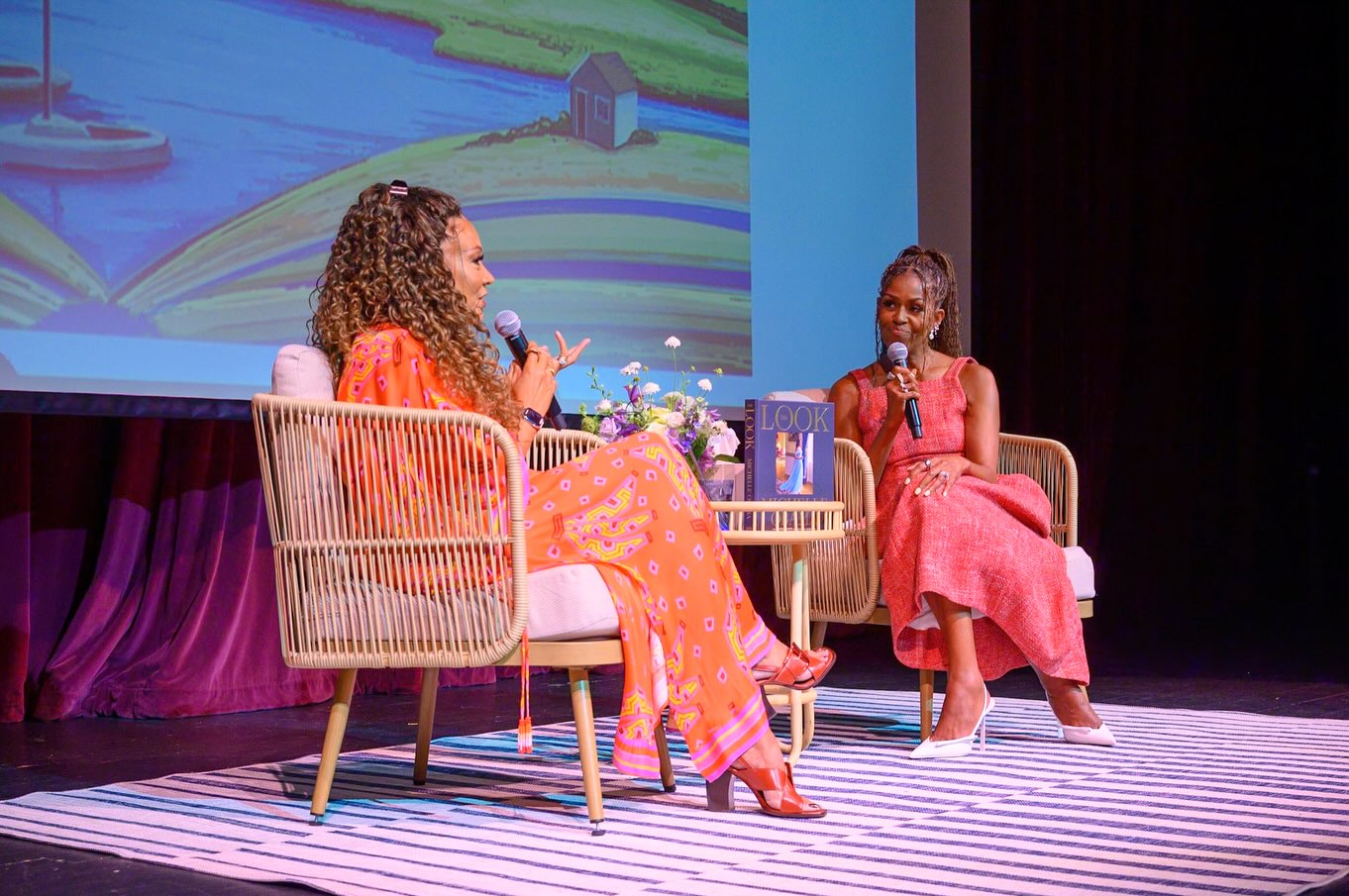 The striped dress was not her only high-fashion moment of the day. In additional photos, she showed off a sleeveless salmon-pink tweed dress featuring thick shoulder straps, a square-cut neckline, and a dramatically full skirt paired with pointed-toe white heels. | Source Instagram/michelleobama