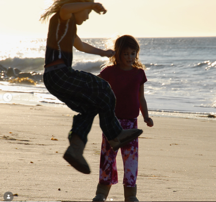 In a playful childhood moment shared on June 25, 2025, a young Presley Gerber leaps into the air beside his younger sister, Kaia Gerber, as they enjoy a sunny day together on the sandy beach. | Source: Instagram/presleygerber