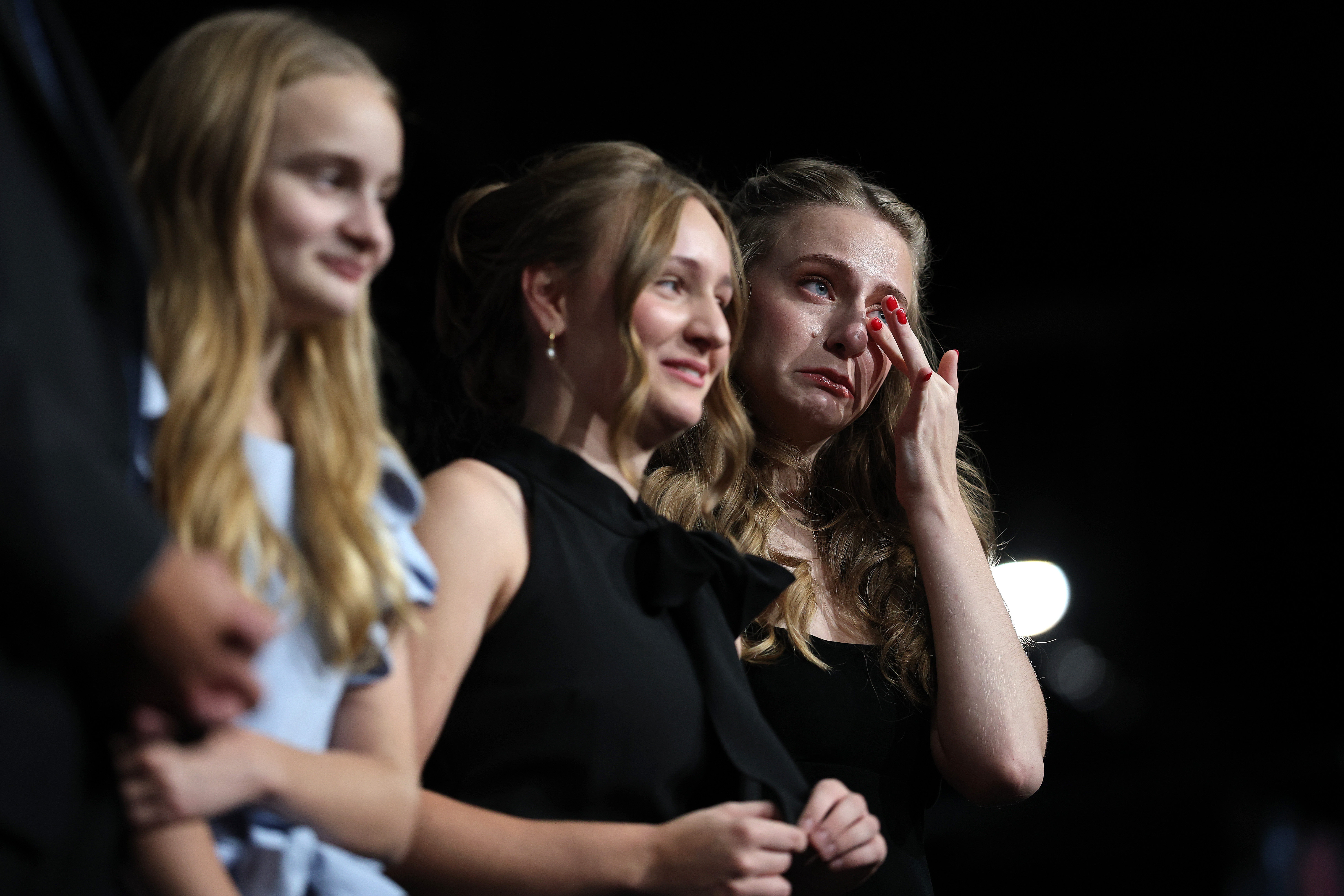 Claire, alongside her sisters Charlotte and Catherine Spanberger, wipes tears from her face as they listen to their mother, Governor-elect Abigail Spanberger, deliver remarks during her election night rally at the Greater Richmond Convention Center on November 4, 2025, in Richmond, Virginia | Source: Getty Images
