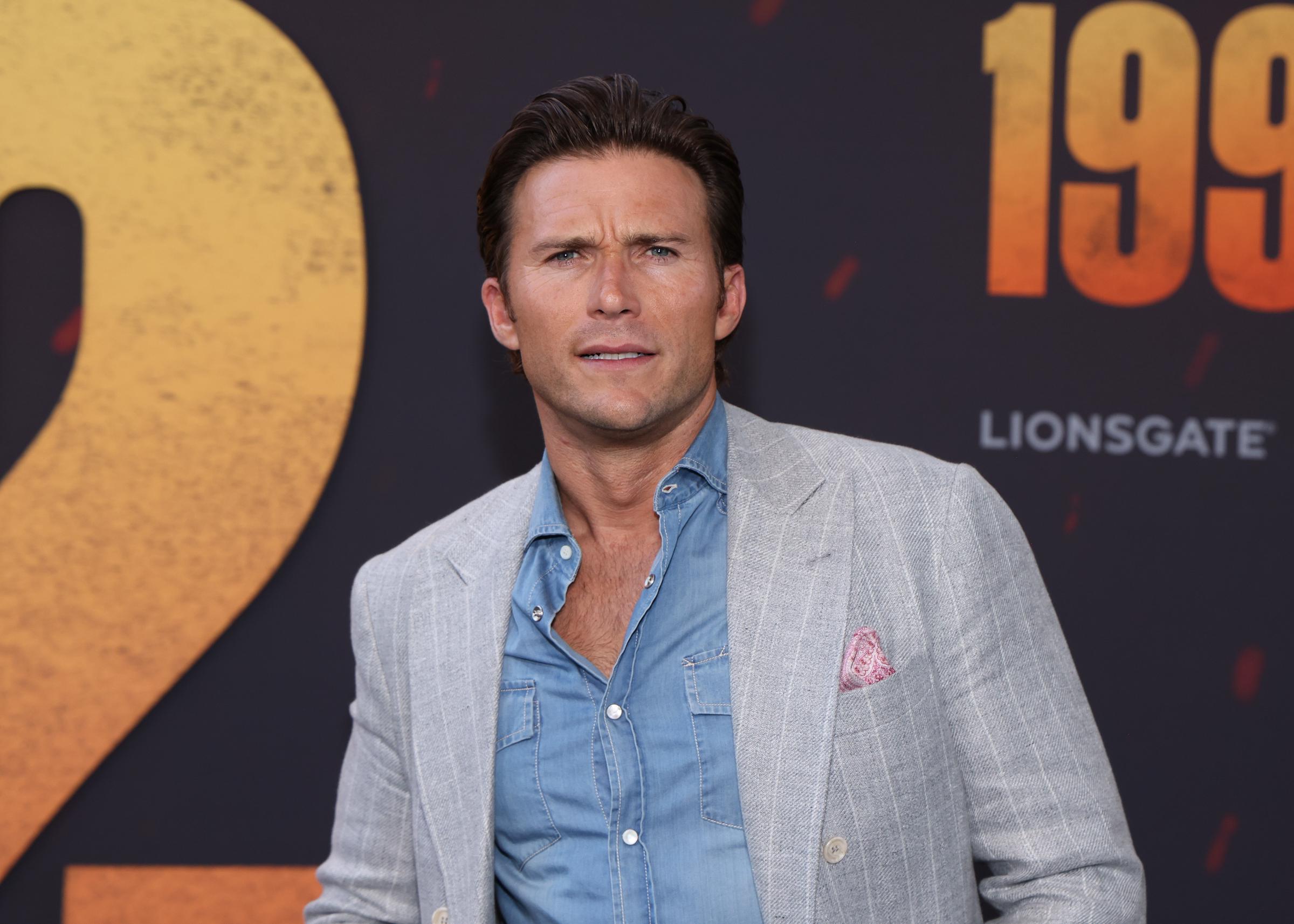 Scott Eastwood stepped onto the red carpet for the "1992" premiere at Regal LA Live in Los Angeles, California, on August 27, 2024. Wearing a light gray pinstriped blazer over an open-collar denim shirt, the actor posed with his dark hair swept back and his striking blue eyes on full display. At 38, Scott's defined jawline, furrowed brow, and intense expression offered a clear look at the features that have prompted netizens to compare him so closely with a young Clint.
