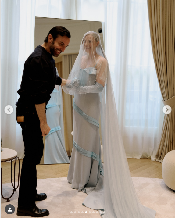 Chloe Moretz interacts with another person during her wedding gown fitting, from a post dated September 1, 2025 | Source: Instagram/chloegmoretz