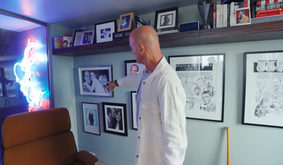 Christopher's office functions like a visual scrapbook, mixing family snapshots with decades of career memorabilia. There is almost more to look at on the walls than there is out of the window. | Source: YouTube/Architectural Digest