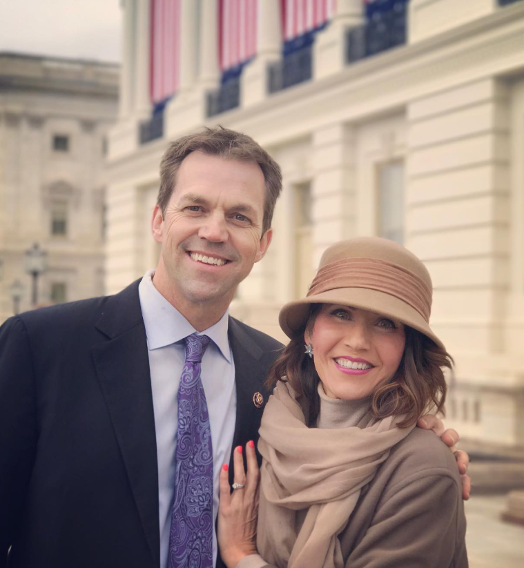 Standing arm in arm outside a stately building, Kristi and Bryon smile toward the camera—polished yet relaxed, blending formality with an easy familiarity. | Source: Instagram/sdbryonnoem