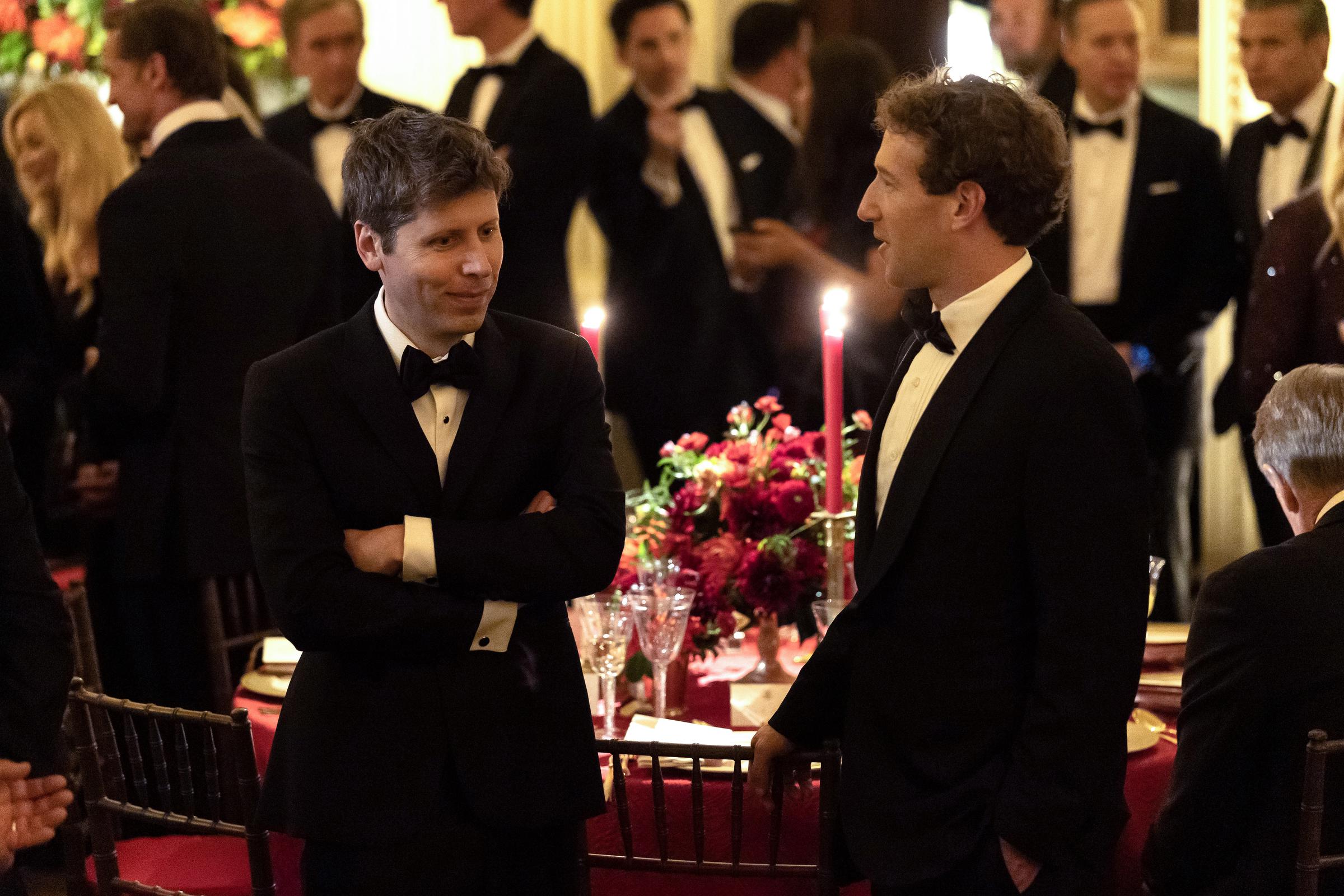 Sam Altman and Mark Zuckerberg engaged in close conversation during the White House state dinner hosted by President Donald Trump for Chinese President Xi Jinping on September 24, 2026, in Washington, DC. Both clad in formal black tuxedos and bow ties, the OpenAI and Meta chief executives stood beside candlelit banquet tables adorned with rich red floral arrangements, chatting animatedly as artificial intelligence, trade, and strategic relations took center stage throughout the diplomatic gathering. | Source: Getty Images