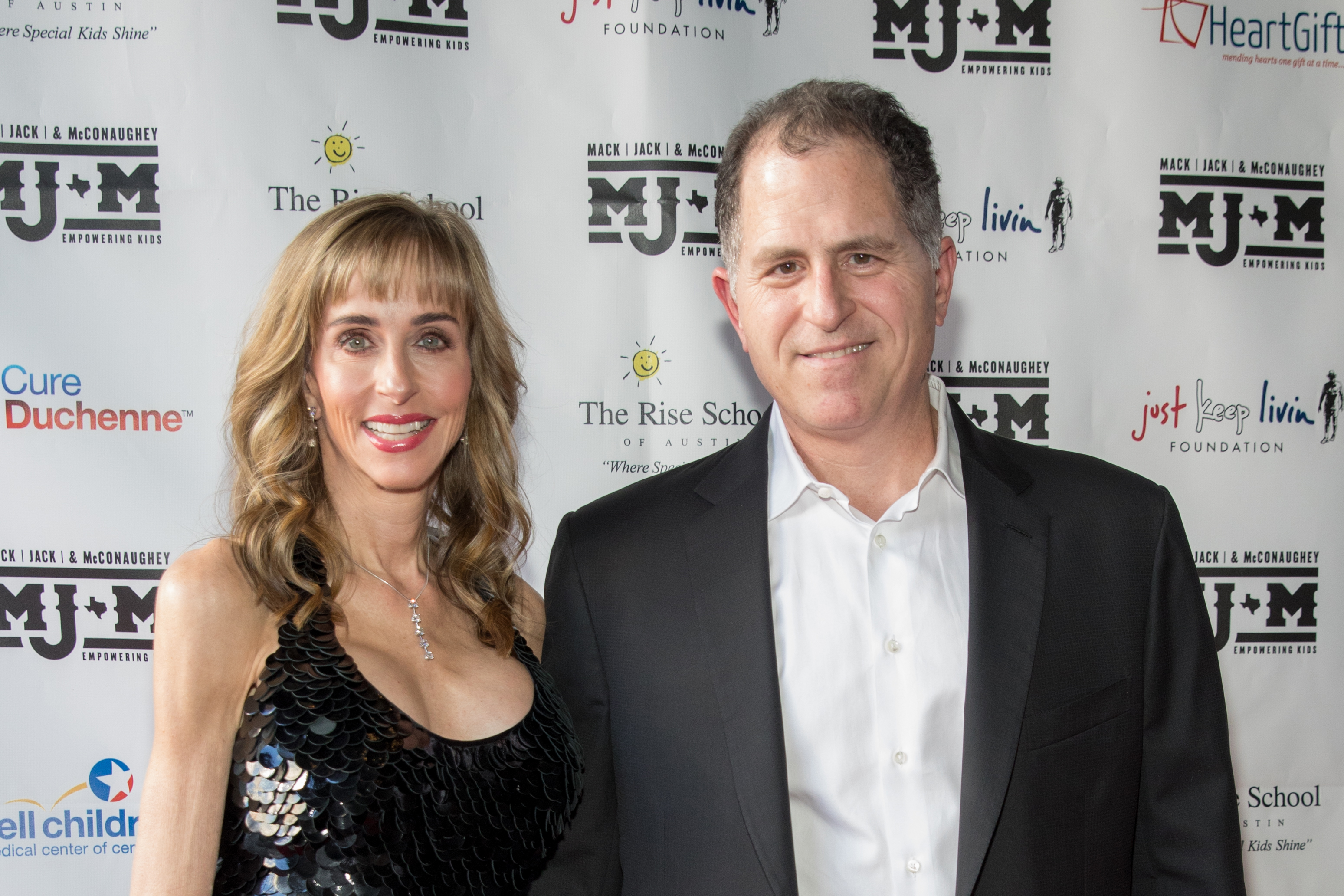 Philanthropists Susan Dell and Michael Dell arrive at the Mack, Jack & McConaughey charity gala at ACL Live in Austin, Texas. Susan wore a shimmering black dress as the couple attended the fundraising event.