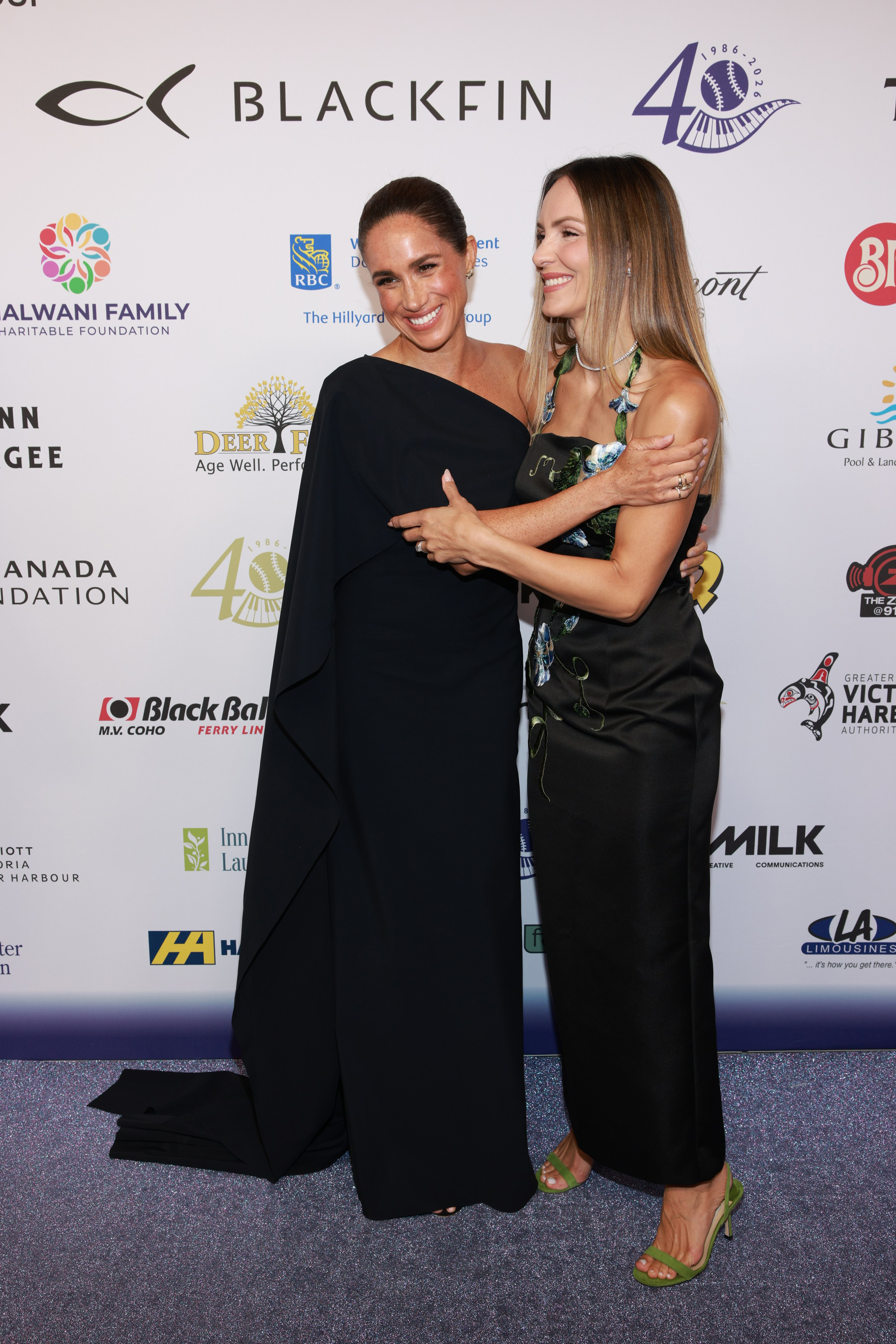 Meghan, Duchess of Sussex and Katharine McPhee smiled together on the red carpet despite sparking mixed reactions from observers online. On this occasion, they attended the David Foster Foundation 40th Anniversary Celebration on August 7, 2026, in Victoria, British Columbia. | Source: Getty Images