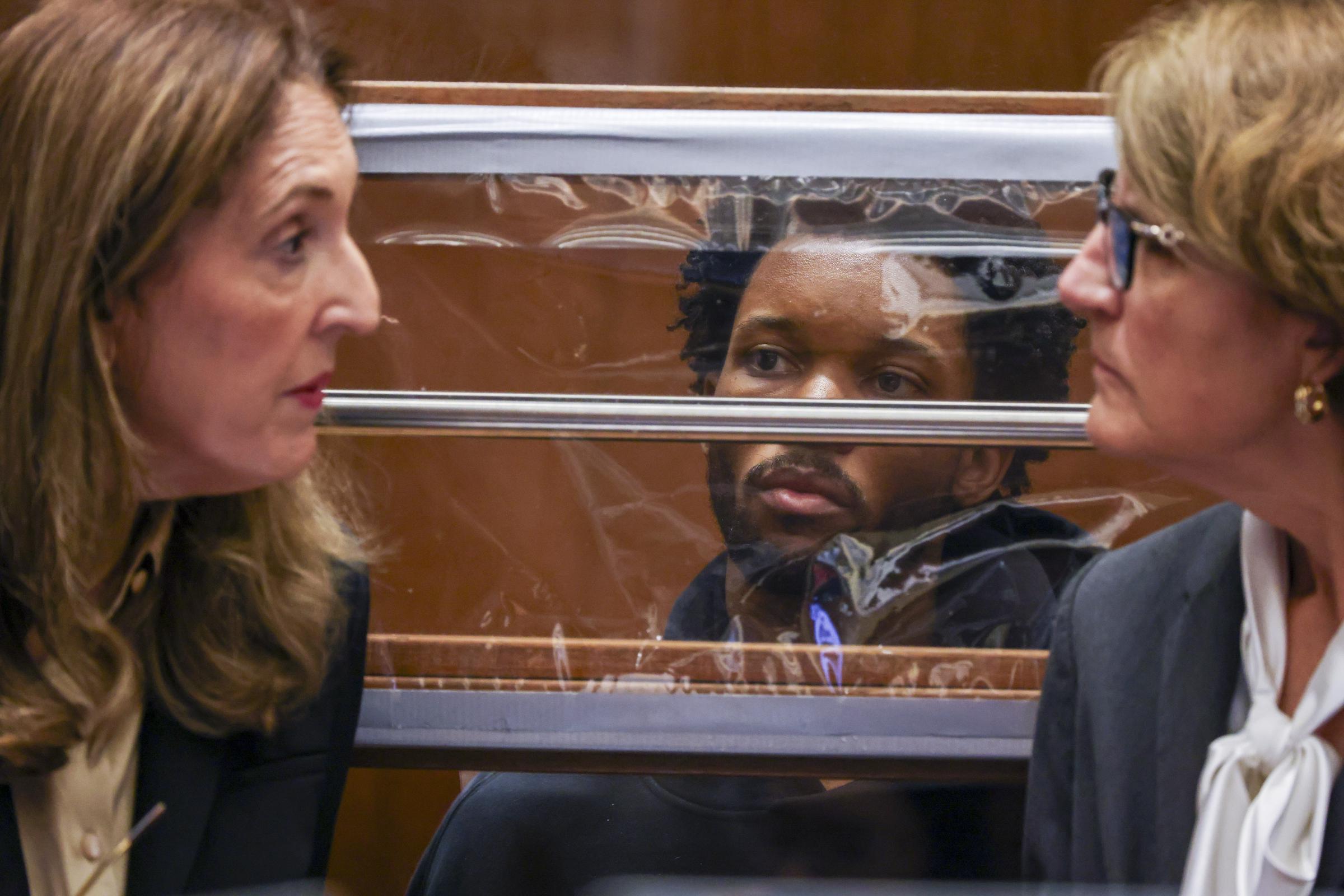 d4vd sits behind a barrier as defense attorneys speak during his arraignment hearing on April 20, 2026 | Source: Getty Images