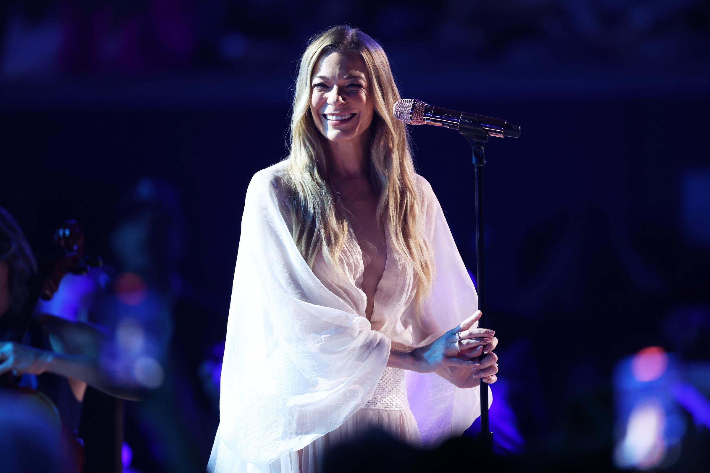 LeAnn Rimes beams on stage in a flowing white gown during her performance at the 60th Academy of Country Music Awards, held on May 8, 2025, in Frisco, Texas | Source: Getty Images