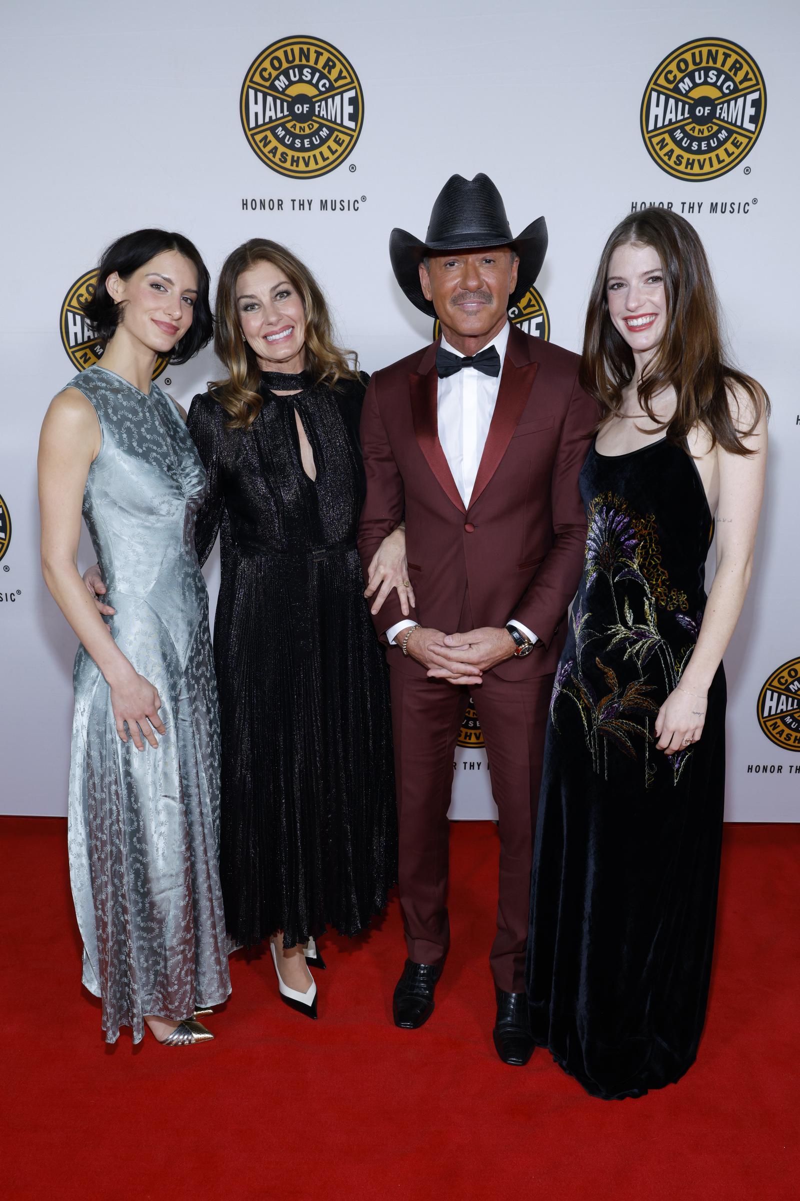 Tim McGraw poses with wife Faith Hill and daughters Audrey (left) and Maggie on the red carpet at the Country Music Hall of Fame and Museum’s 2026 Medallion Ceremony in Nashville, Tennessee, on October 18, 2026. | Source: Getty Images