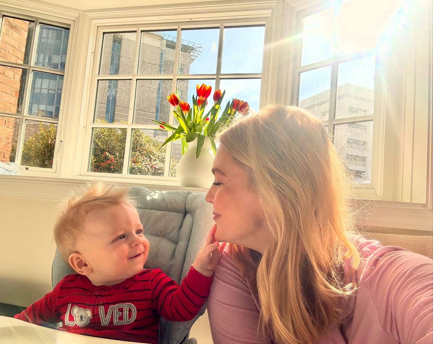 Huge windows are one of the Washington home's recurring visual signatures, and this photo shows exactly how much daylight they bring inside. The warm mother-and-son moment also hints at why Leavitt ultimately decided that time with her children had to take priority. | Source: Instagram/karolineleavitt