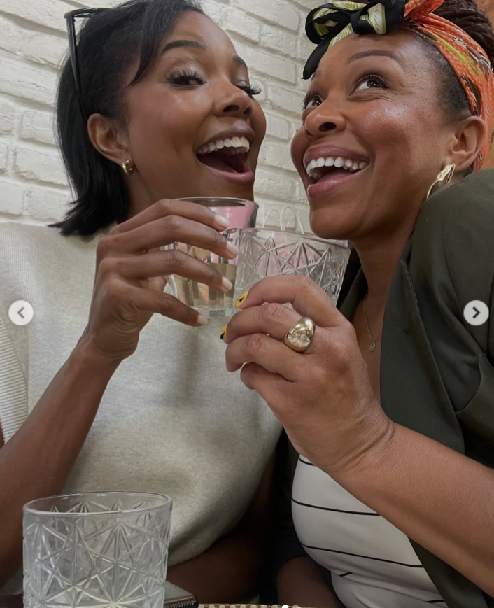 Gabrielle Union raises a glass in a cheerful toast with another woman, both smiling and leaning close together in a candid, celebratory moment. | Source: Instagram/gabunion