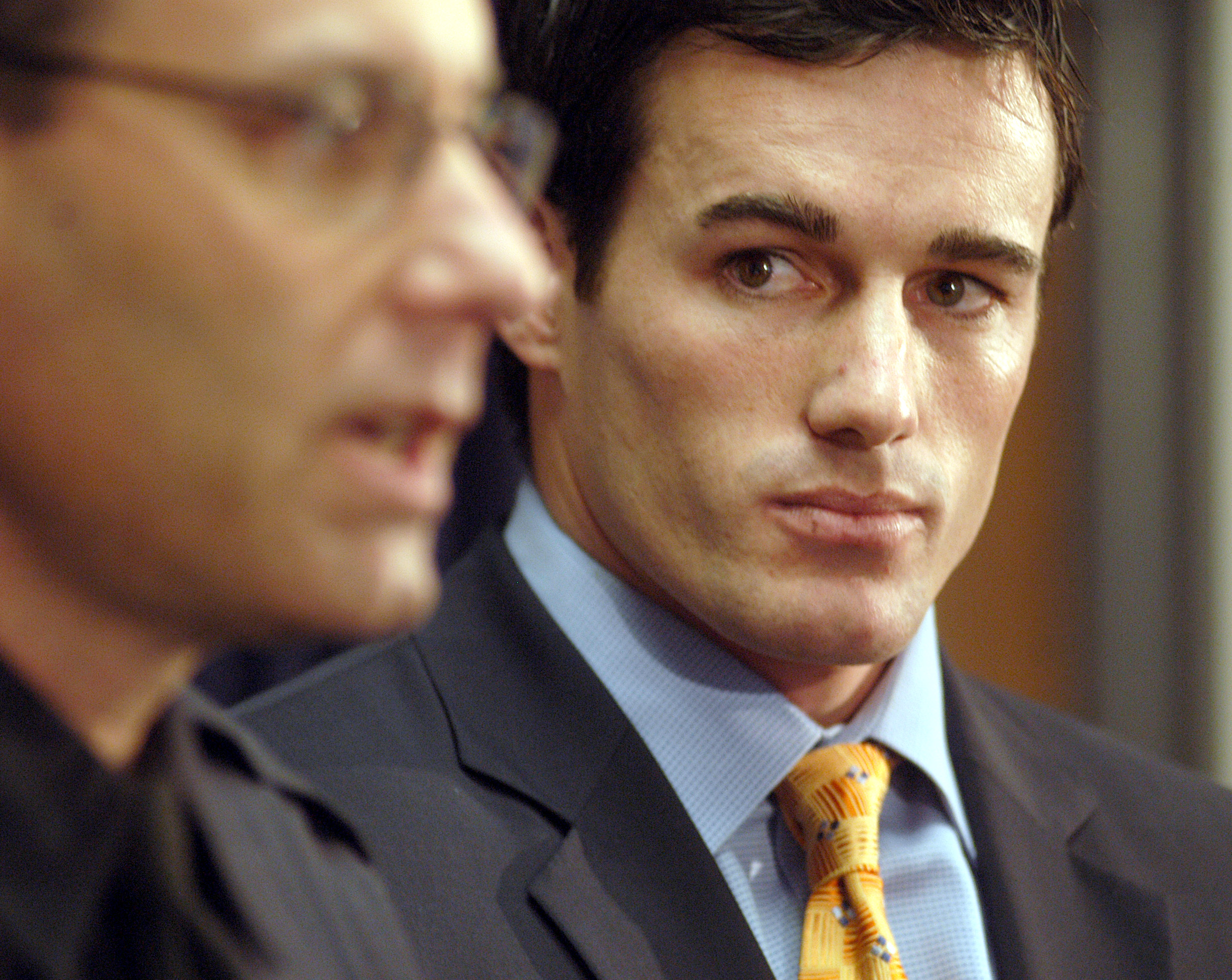 Ryan Hawks listened as Newport Beach Police Department Sgt. Steve Schultz reviewed a timeline of the disappearance of his father, Thomas Hawks, and stepmother, Jackie Hawks, on March 4, 2005. Photographed in a suit and tie as Schultz spoke beside him, Ryan followed the discussion months after the couple vanished following plans to sell the 55-foot yacht they had called home during their retirement.