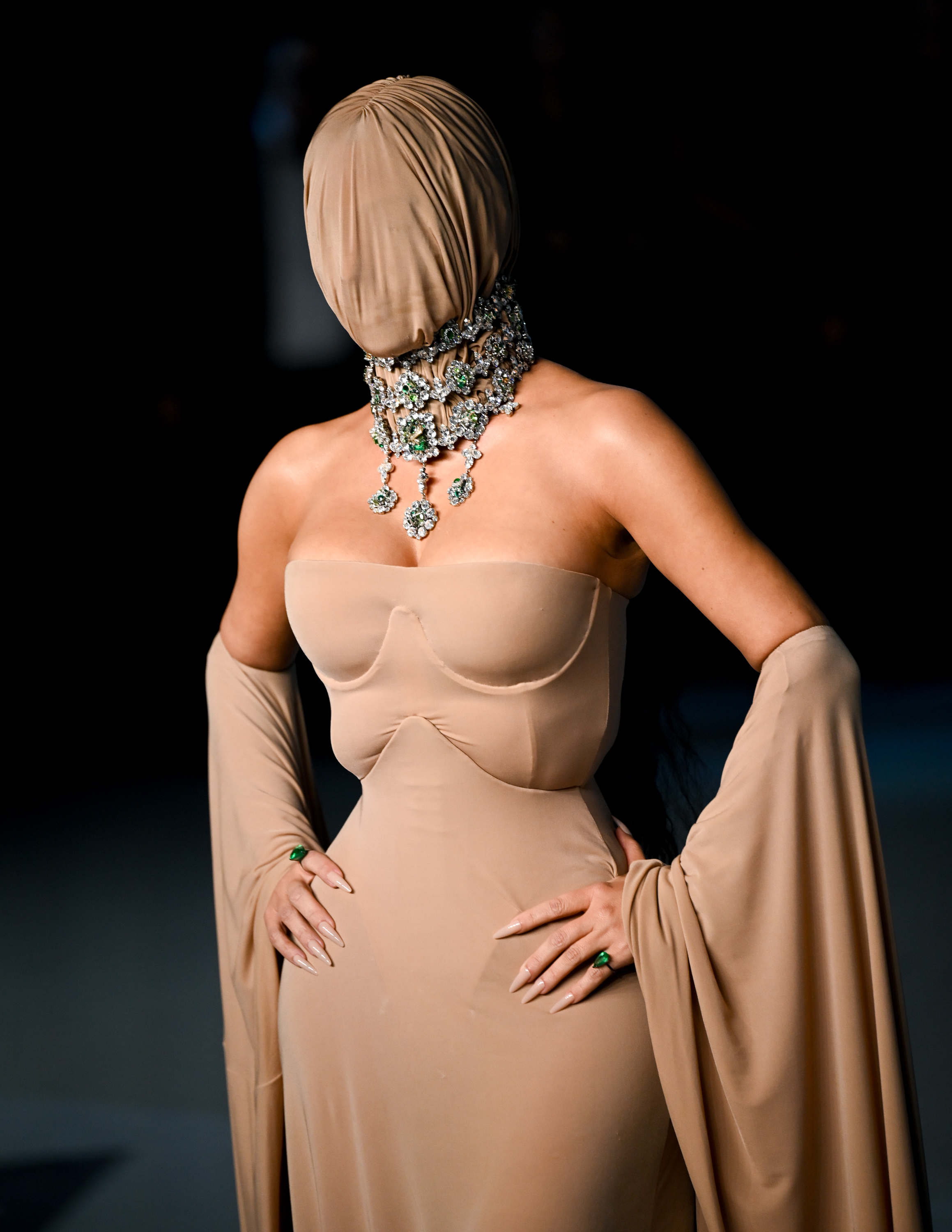 A view of Kim Kardashian's nude face mask and dress. | Source: Getty Images