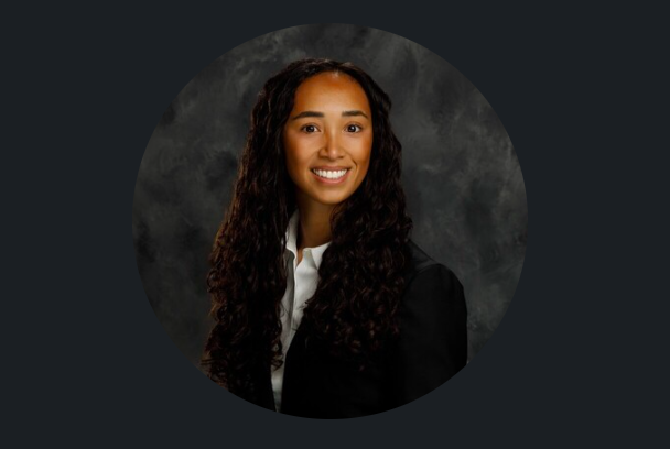 Kaia Harris smiles in a professional portrait while wearing a black blazer over a white collared shirt. | Source: LinkedIn/Kaia Harris