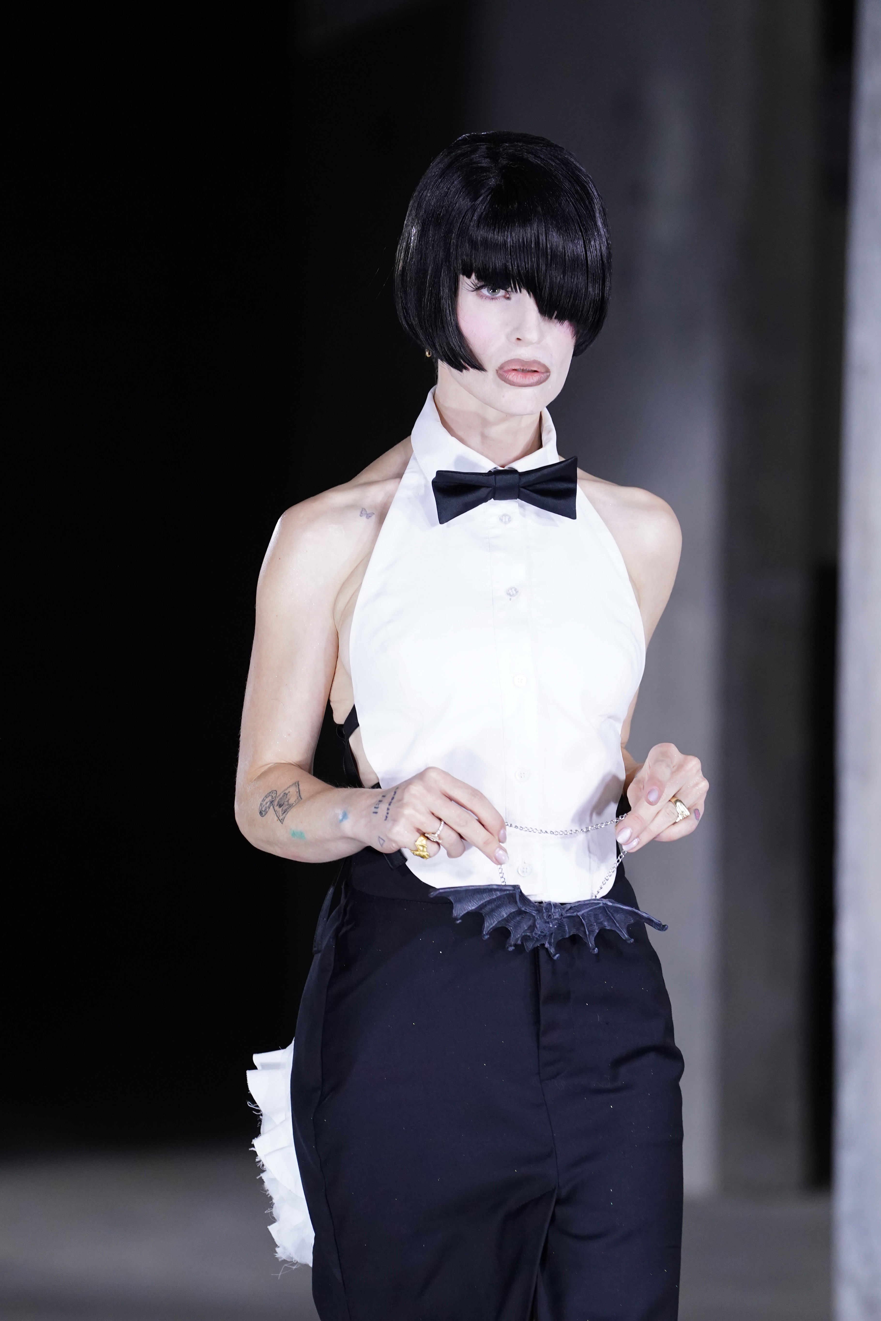 Kelly Osbourne walks the runway at Natasha Zinko's Spring/Summer 2027 show during London Fashion Week, holding a black bat ornament by a silver chain. | Source: Getty Images