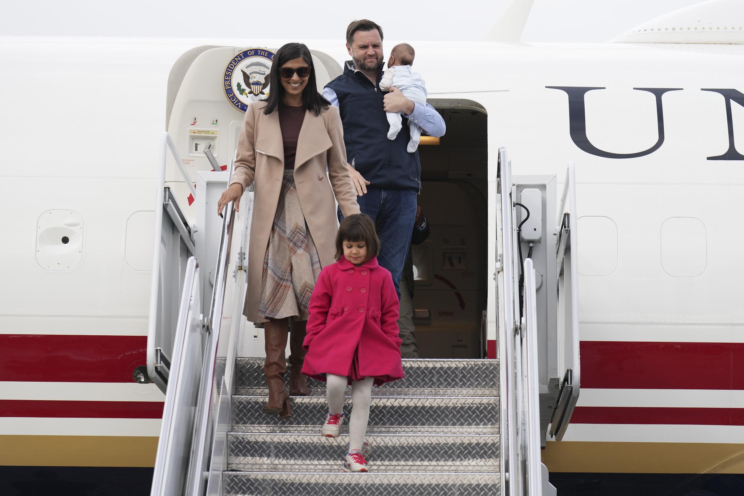 Usha and Mirabel lead the way down the steps while JD follows carrying Alec, capturing the clothing contrast that later drew attention from commenters. | Source: Getty Images