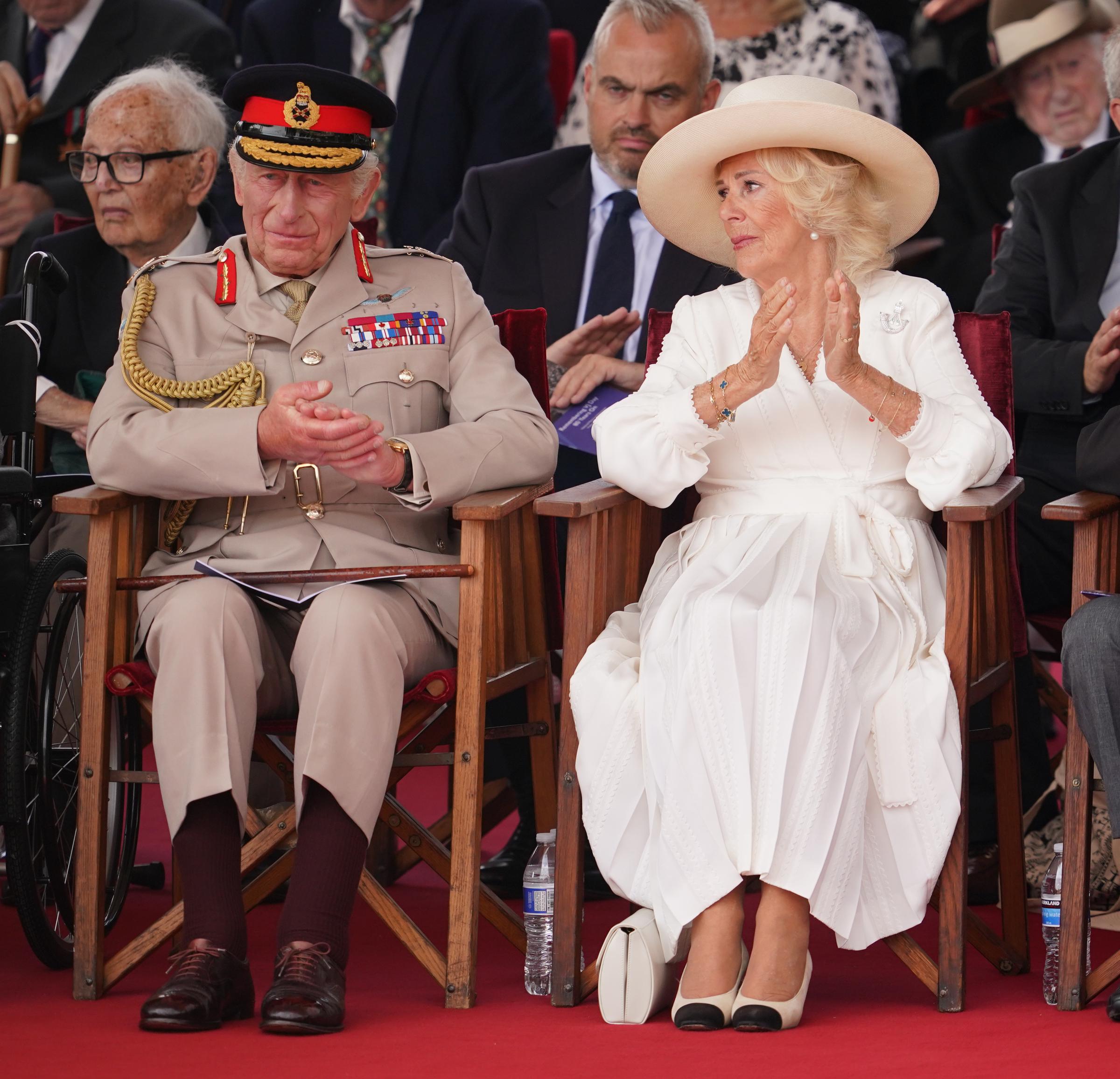 King Charles III and Queen Camilla react during a Service of Remembrance to commemorate the 80th Anniversary of VJ Day at The National Memorial Arboretum on August 15, 2025, in Alrewas, Staffordshire | Source: Getty Images