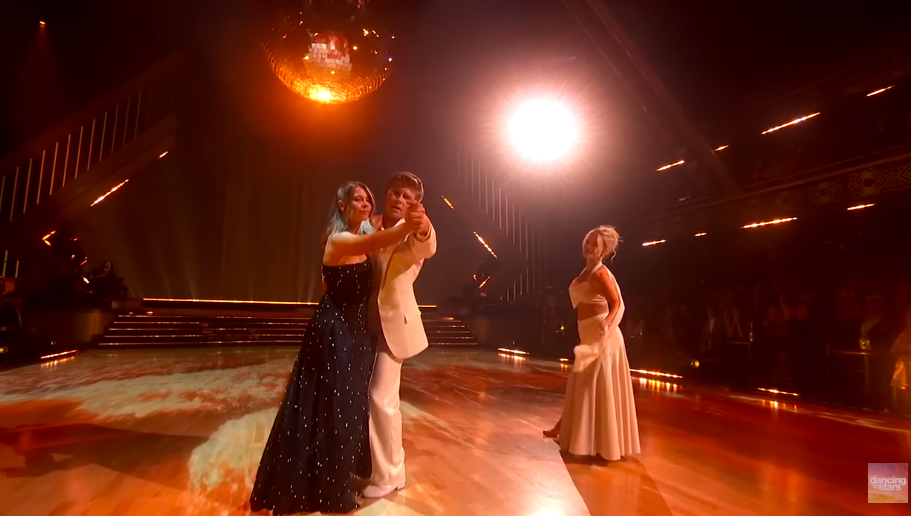 Bindi and Robert Irwin joining hands on stage as Witney Carson looks on. | Source: YouTube/Dancing With The Stars