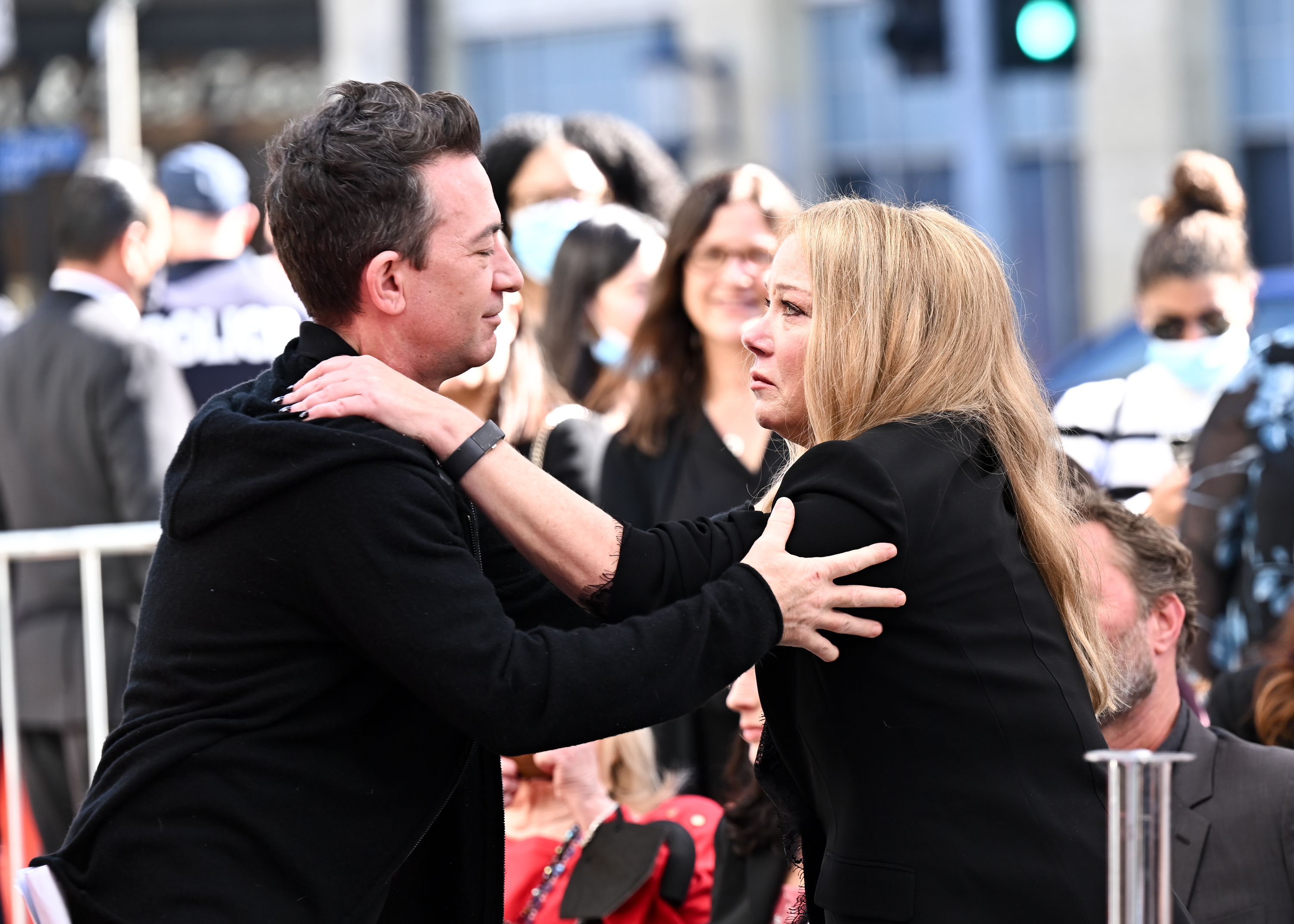 David Faustino and Christina Applegate shared an emotional embrace as Applegate was honored with a star on the Hollywood Walk of Fame on November 14, 2022, in Los Angeles, California. The "Married... with Children" co-stars reunited for the milestone ceremony, with Faustino offering loving support in a black hoodie while Applegate looked visibly moved in a chic tailored black suit. | Source: Getty Images