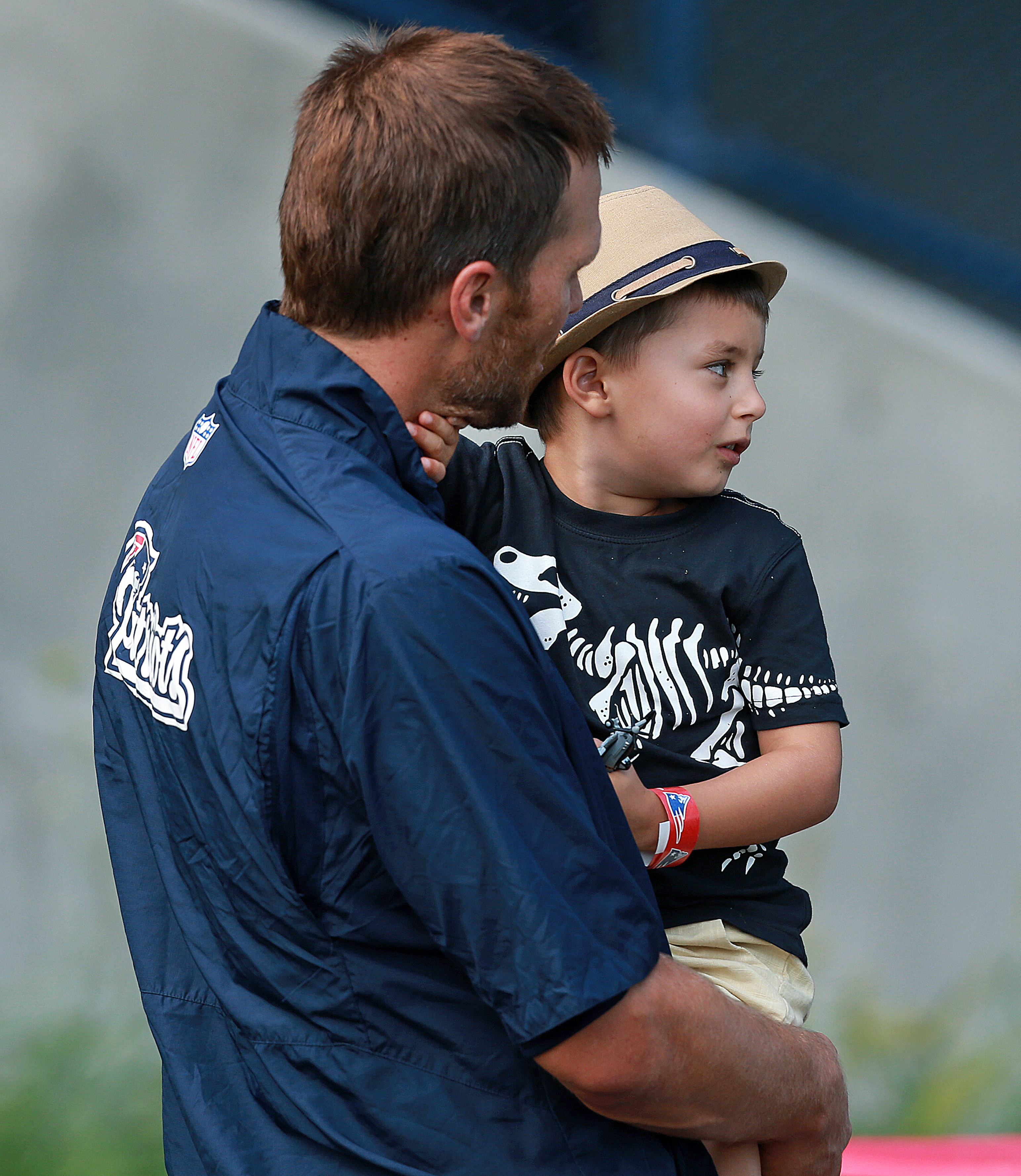 A photo taken after a New England Patriots practice session shows Benjamin as a young child sitting comfortably in his father's arms. Dressed in a graphic T-shirt and a small hat, Benjamin still had the unmistakable look of a little boy who accompanied his father to football events.