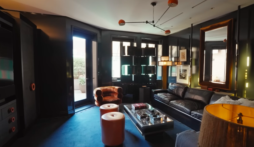 The room has a private-club feeling, but Kelly and Mark's humor keeps it from becoming too serious. It is dramatic without being humorless. | Source: YouTube/Architectural Digest