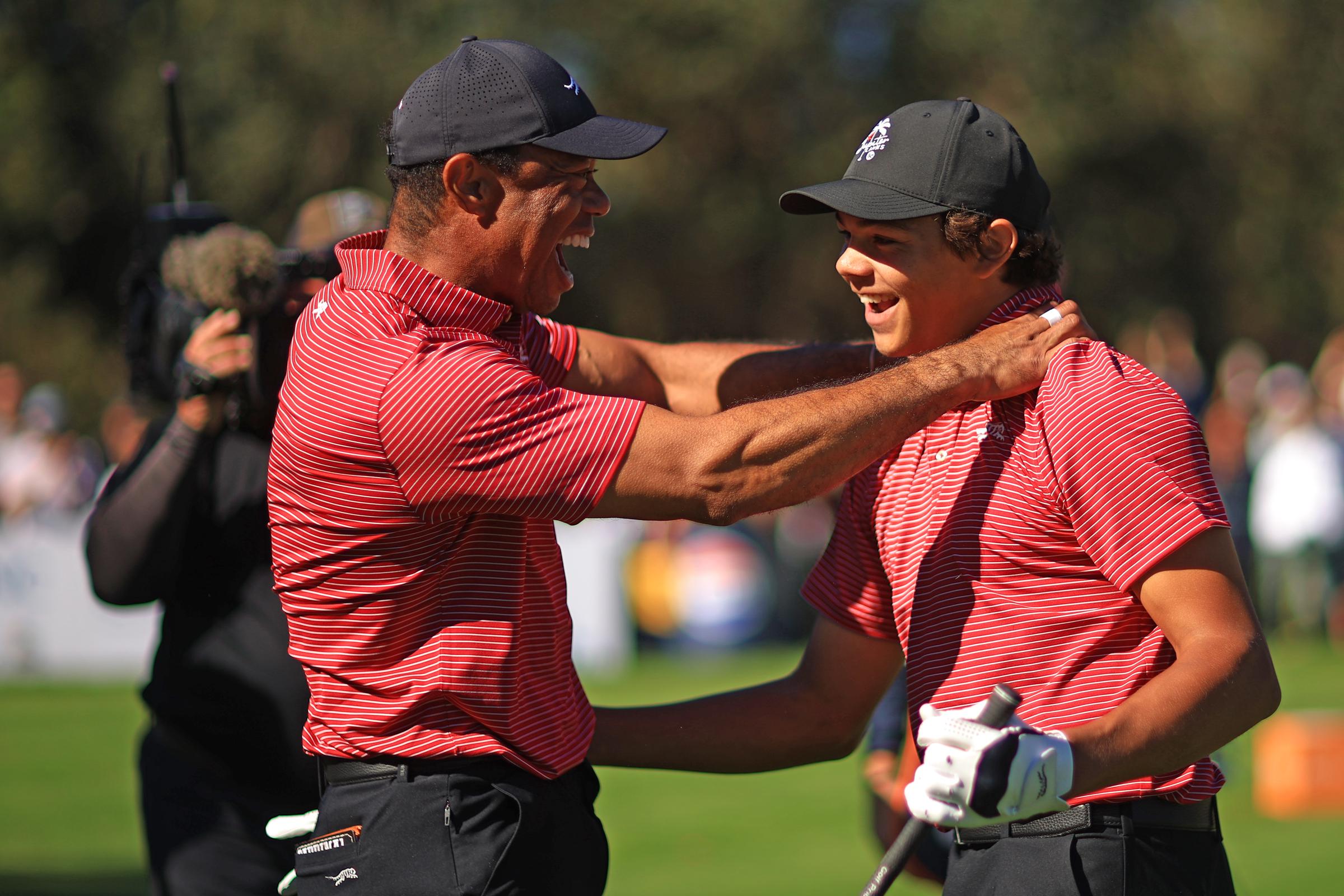 Tiger Woods and Charlie Woods react after Tiger made the first hole-in-one of his career on the fourth hole during the second round of the PNC Championship at Ritz-Carlton Golf Club on December 22, 2024, in Orlando, Florida | Source: Getty Images