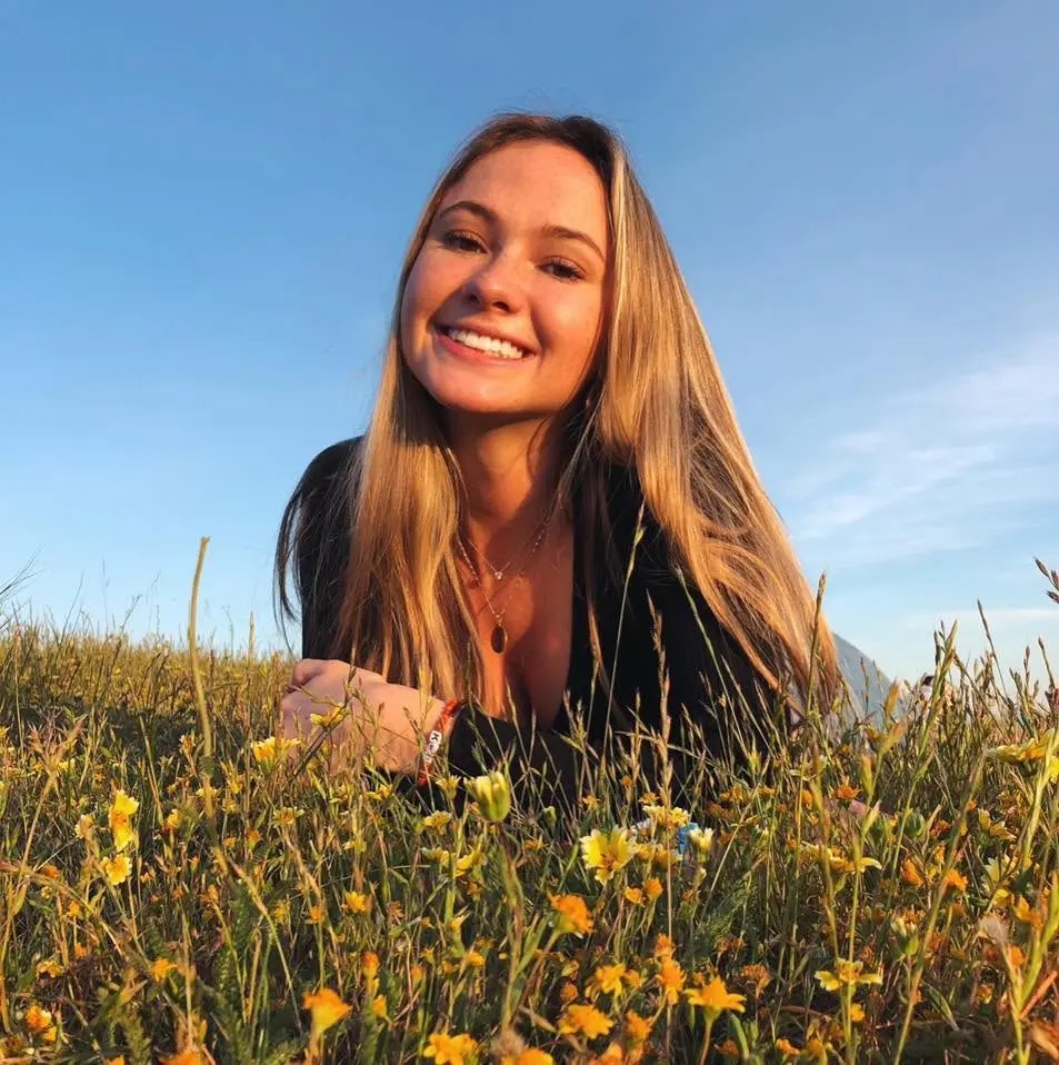 Katherine “Katie” Mannix, 24, smiles in a field of yellow wildflowers. The youngest of Ann Mannix’s three children, she was remembered by loved ones for her warmth and playful personality. | Source: Facebook/@katie.mannix.98